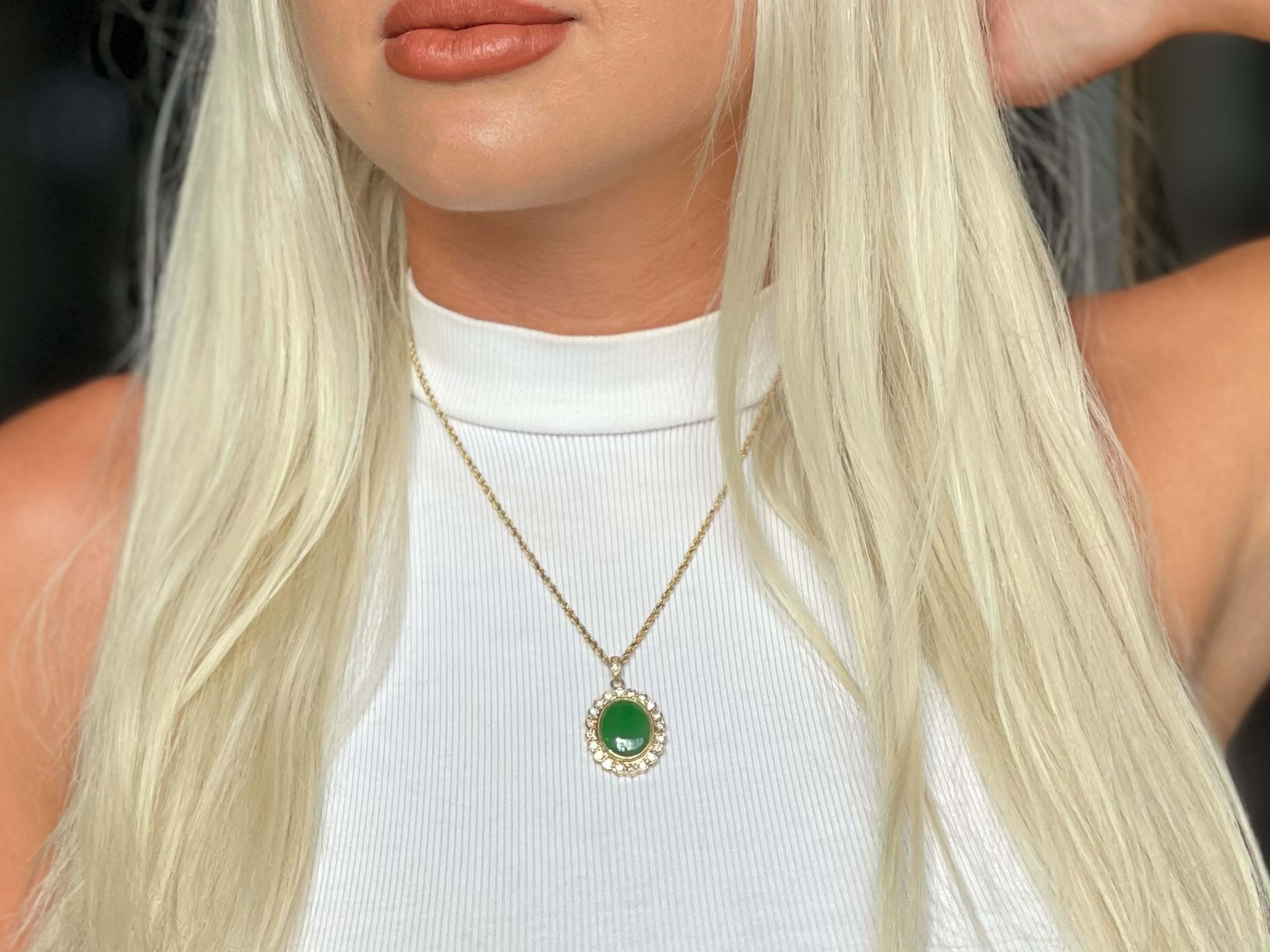 GIA Vintage Oval Cabochon Green Translucent Jadeite Jade and Diamond Pendant in 14k Yellow Gold. This stunning pendant is set with a gorgeous oval shape double cabochon green jadeite jade with a round brilliant diamond halo. The center Jadeite Jade