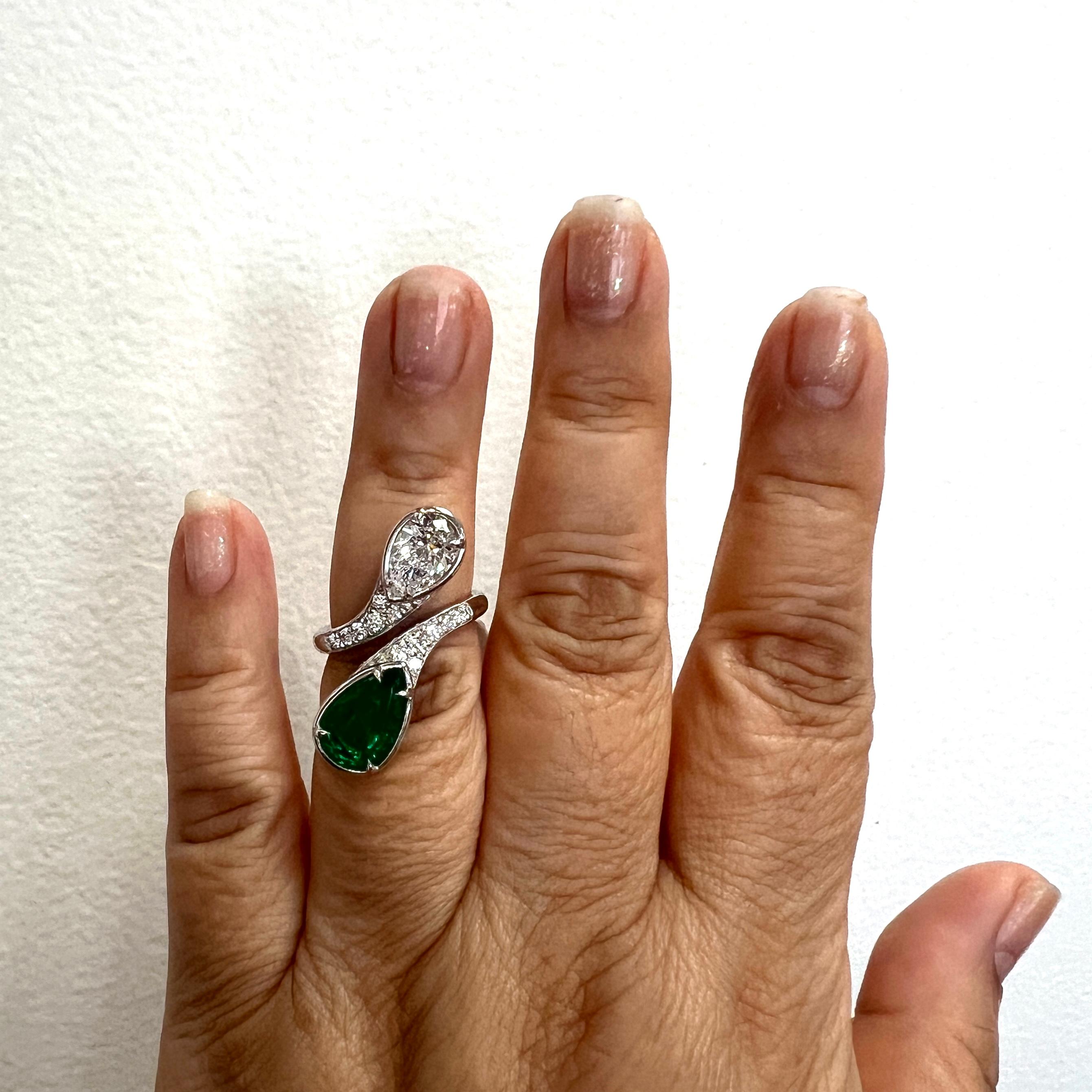 Gorgeous 1.69 ct. D VVS2 white diamond pear shape with a 4.24 ct. emerald pear shape.  Handmade in platinum.  Ring size 6.  GIA certificate included.