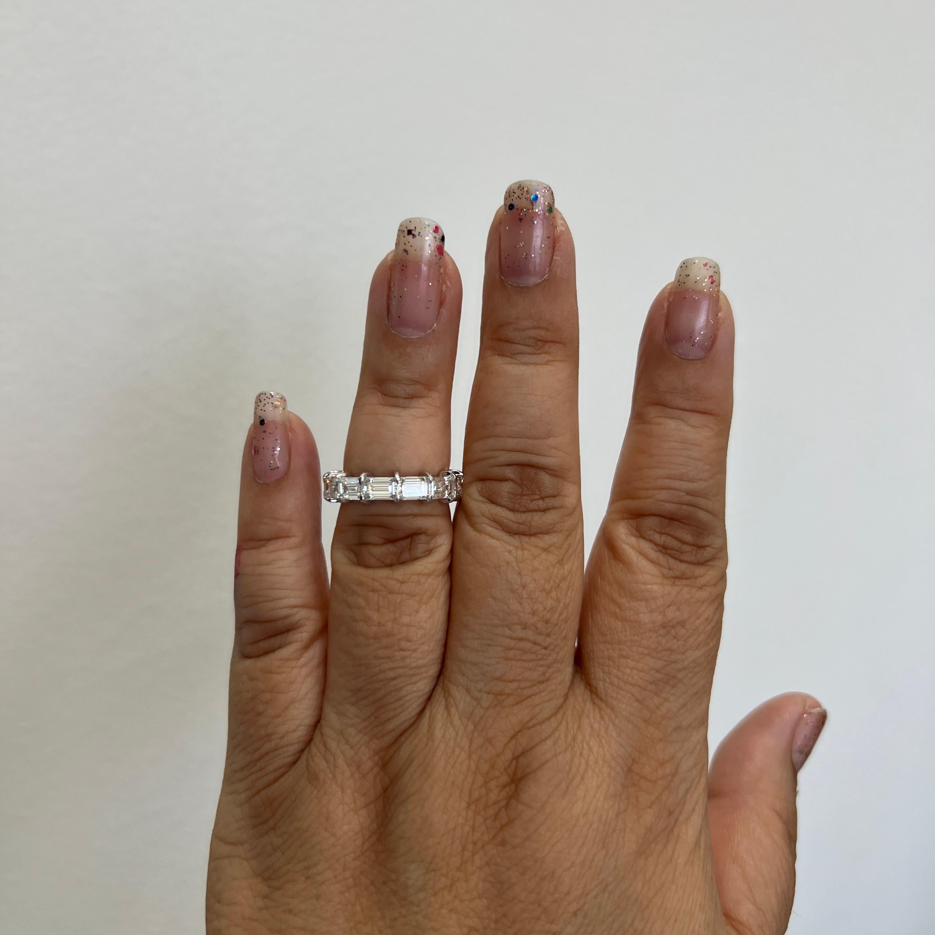 Gorgeous 5.33 ct. HI VS white diamond emerald cuts.  Total of 13 stones, each weighing 0.40 ct.  The stones are set sideways which gives the eternity band a more contemporary and trend forward feel.  Handmade in 18k white gold.  Ring size 6.5.  All