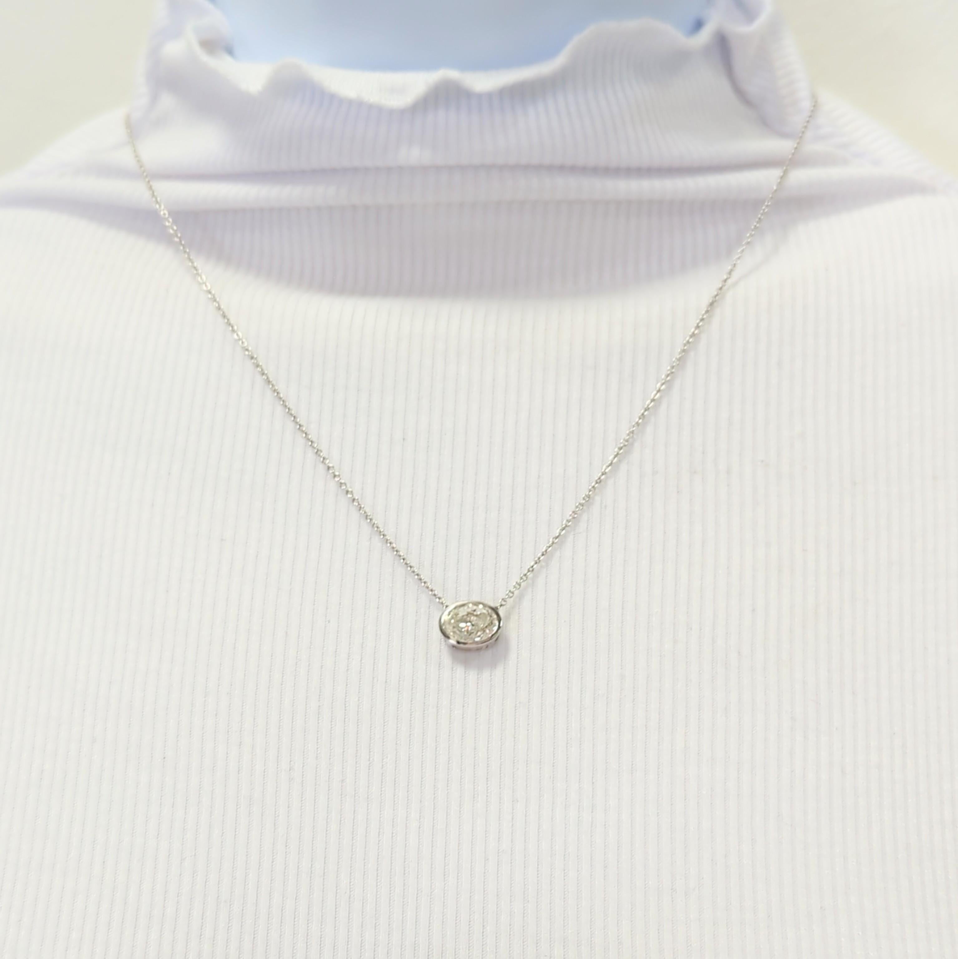Gorgeous 2.01 ct. I SI2 oval white diamond in a handmade 18k white gold bezel pendant.  Length is 18.5