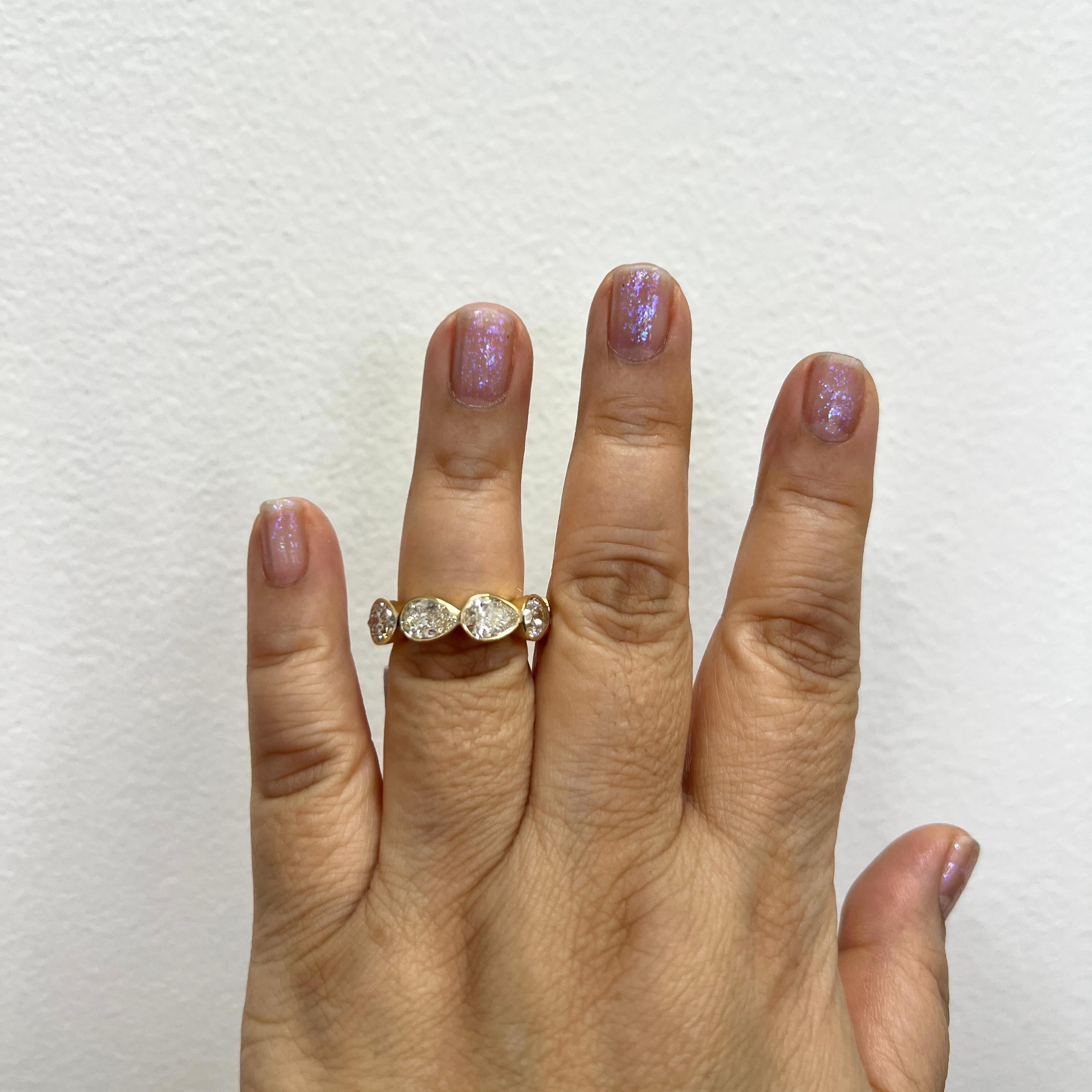 Stunning 9.00 ct. IJ VVS-SI white diamond pear shapes.  Each stone weighs 1.00 ct., total of 9 stones.  Handmade in 18k yellow gold.  Ring size 7.  GIA certificates included.  


