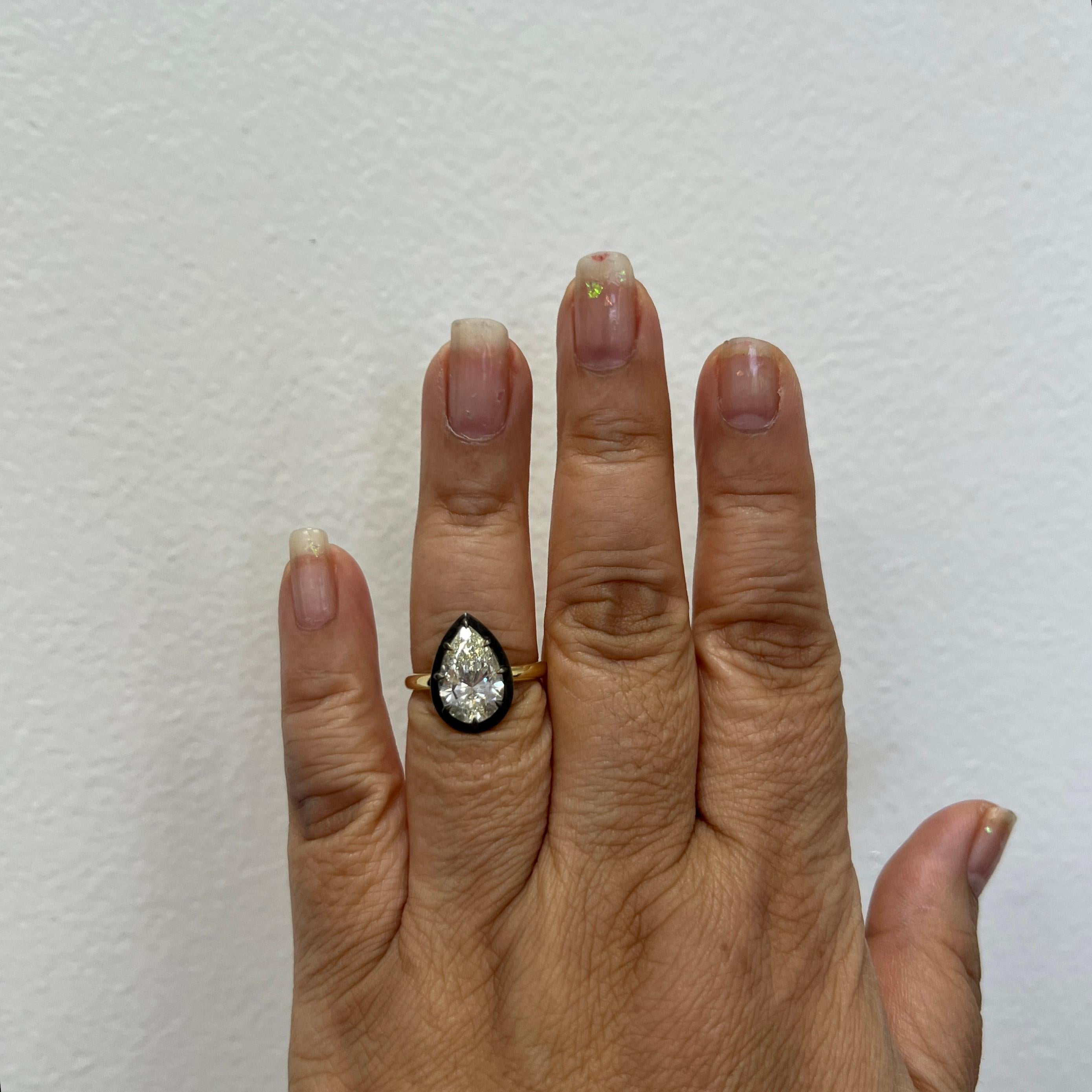 Gorgeous 3.20 ct. K VS2 white diamond pear shape.  Handmade in 18k yellow gold and black rhodium.  GIA certificate included.  Ring size 6.5.

