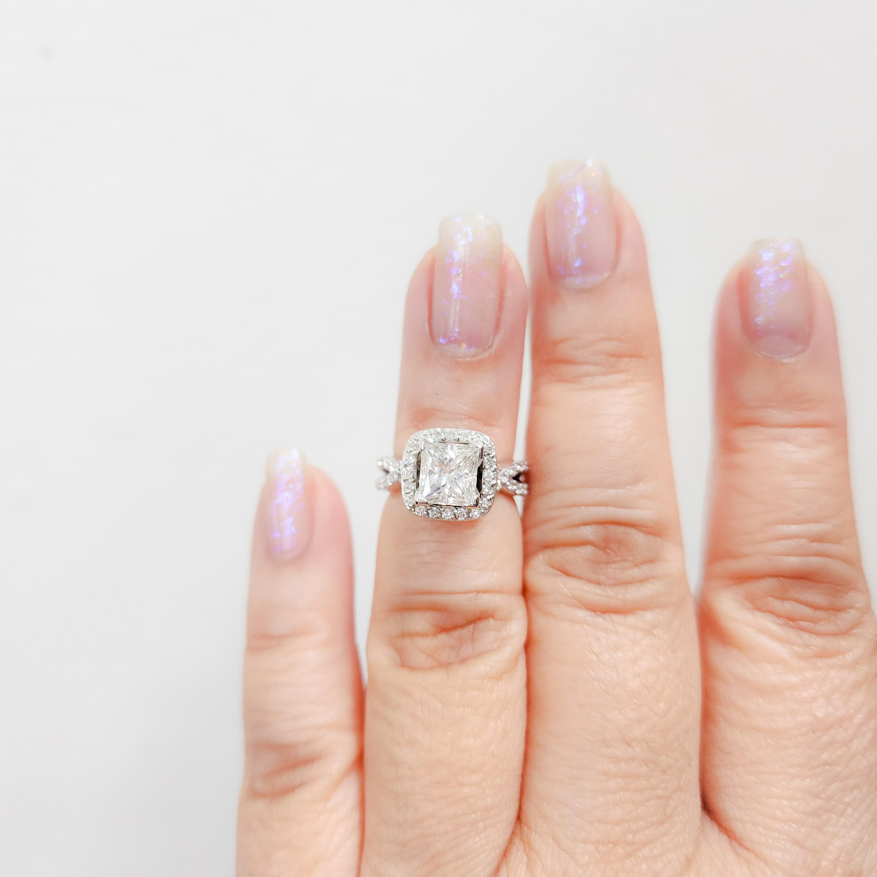 Beautiful 1.57 ct. D VVS2 white diamond rectangular cut with smaller white diamond rounds as accents.  Handmade in 14k white gold.  Ring size is 4.  GIA certificate included.