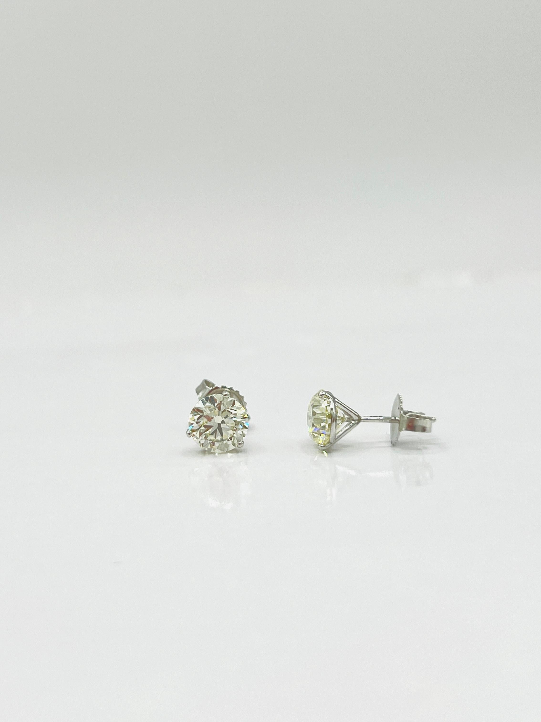 Beautiful 3.02 ct. M VS1-VS2 (1.51 + 1.51) white diamond rounds.  Handmade in 18k white gold, 4 prong, push back, martini setting.  GIA certificates included.