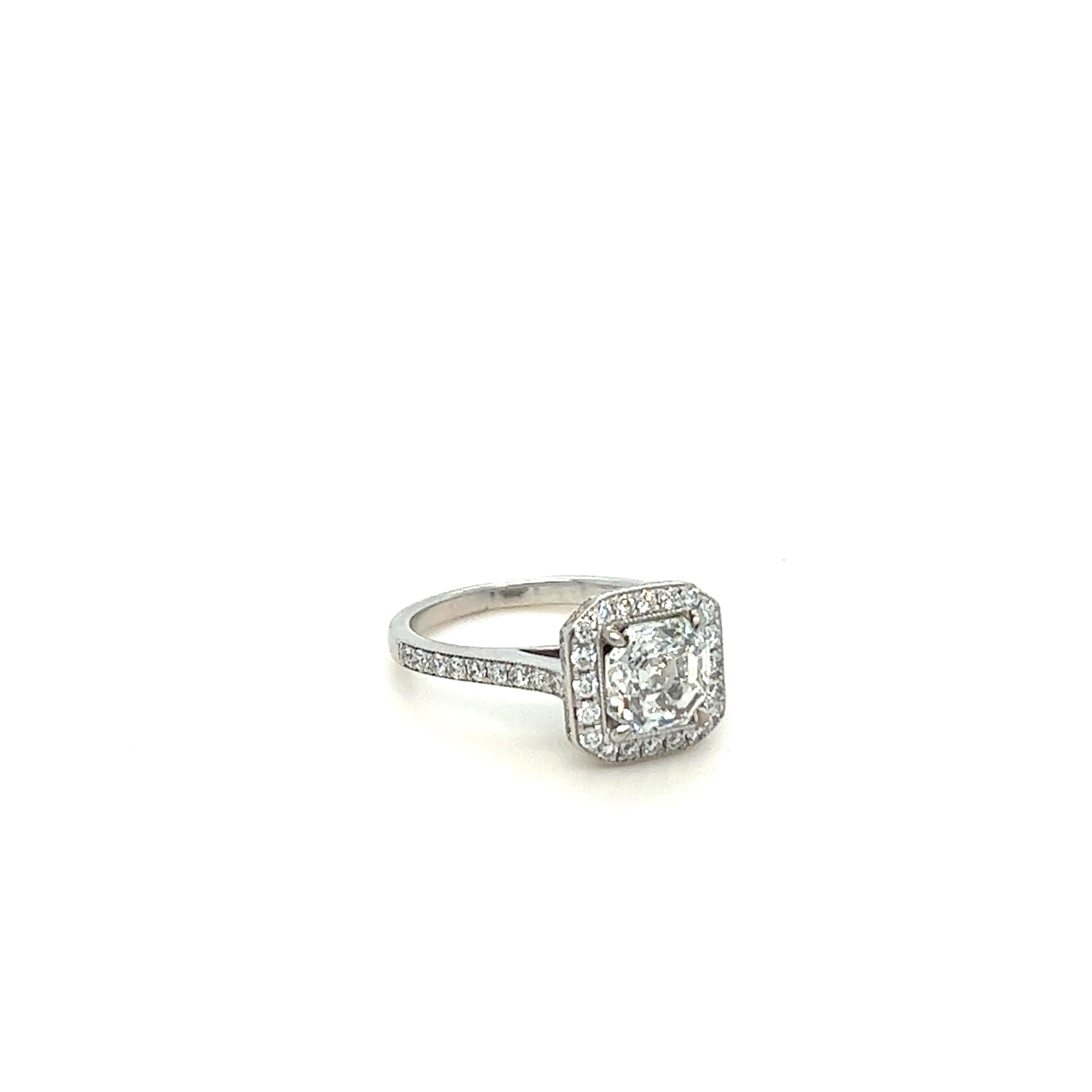 Unique features: 
GIA White Gold Asscher Cut Engagement Ring 1.56ct

18ct white gold, combination machine and handmade halo style diamond.

Surrounding the central Asscher cut diamond, in a bead set frame, are twenty round brilliant cut diamonds,