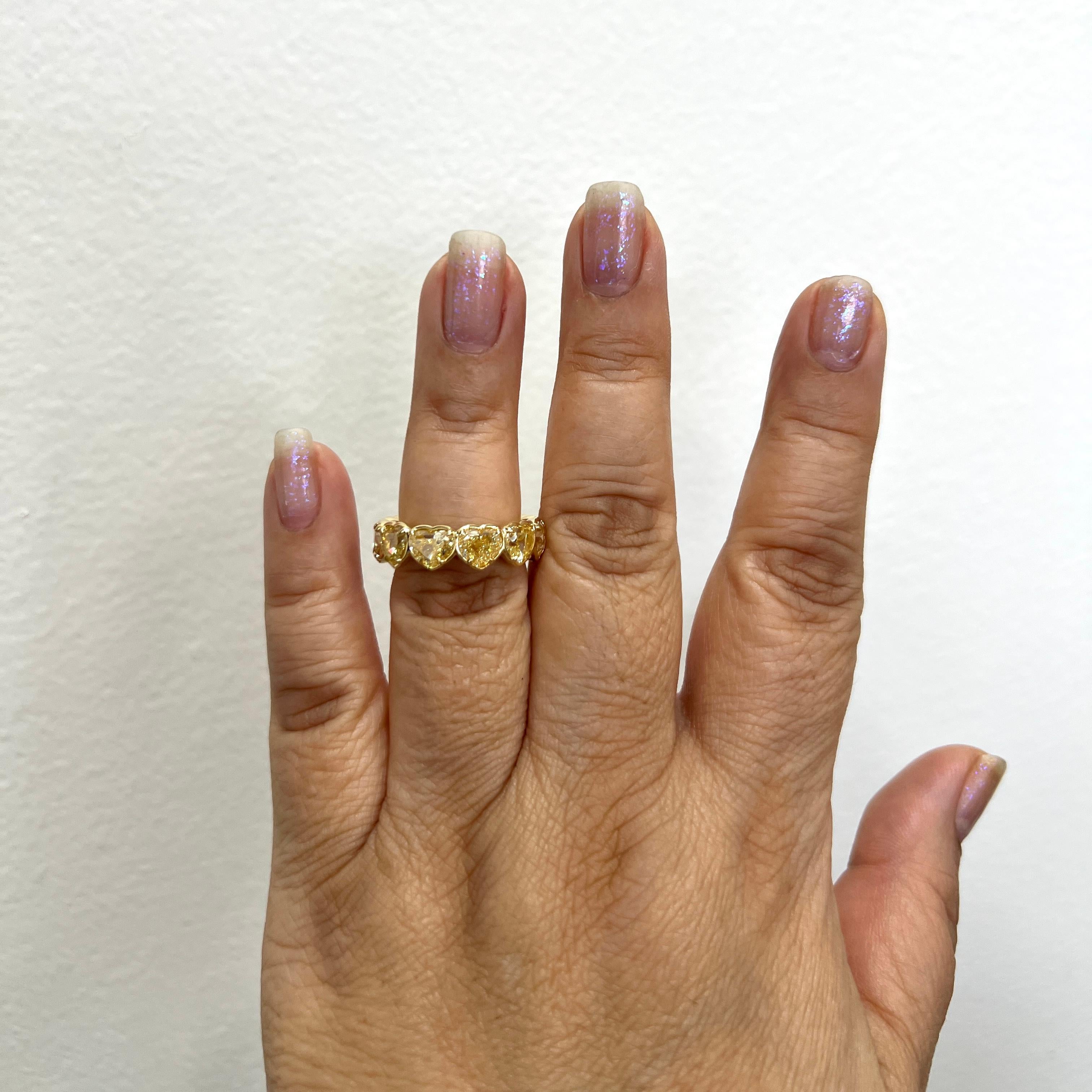 Stunning 11.08 ct. fancy light yellow to fancy yellow VS - SI yellow diamond heart shapes.  Total of 11 stones, each one weighs 1.00 ct.  Handmade in 18k yellow gold.  Ring size 6.75.  Each stone comes with a GIA certificate.

