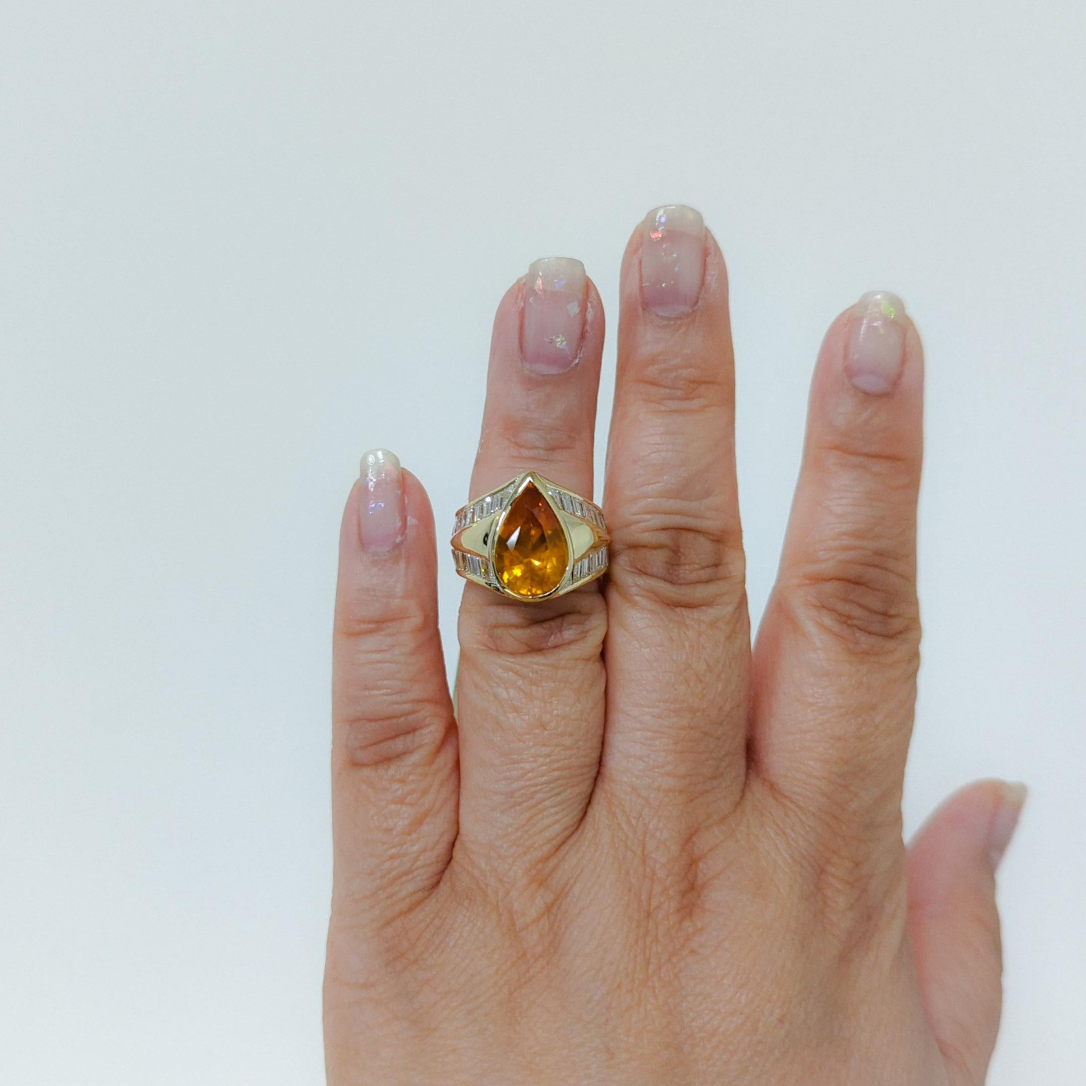 Absolutely stunning 6.65 ct. GIA certified yellow orange sapphire pear shape with 4.00 ct. good quality white diamond baguettes.  Handmade in 18k yellow gold.  Ring size 6.25.  GIA certificate included.