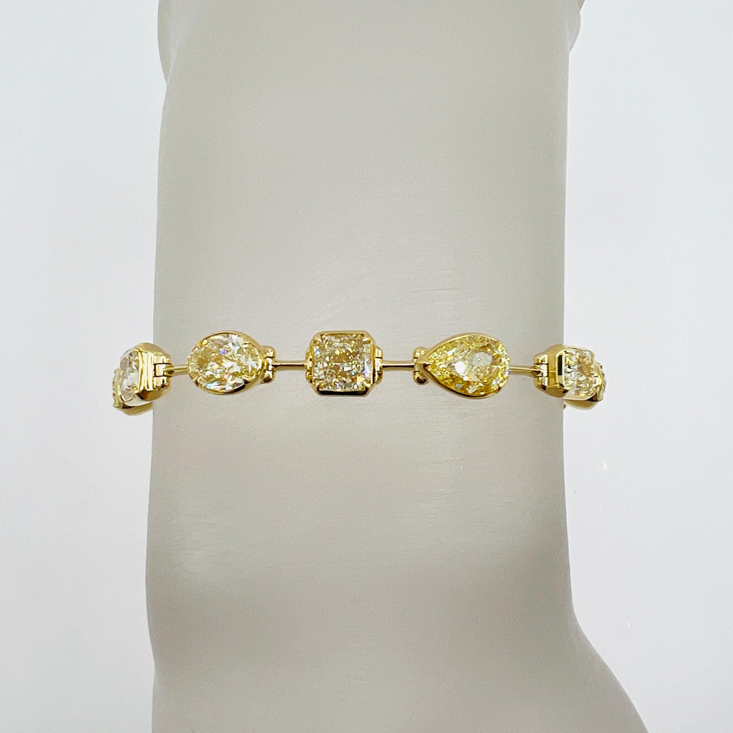 Stunning 13.80 ct. S-Z VVS-SI oval, pear, and radiant diamonds.  Handmade in 18k yellow gold.  Length is 7