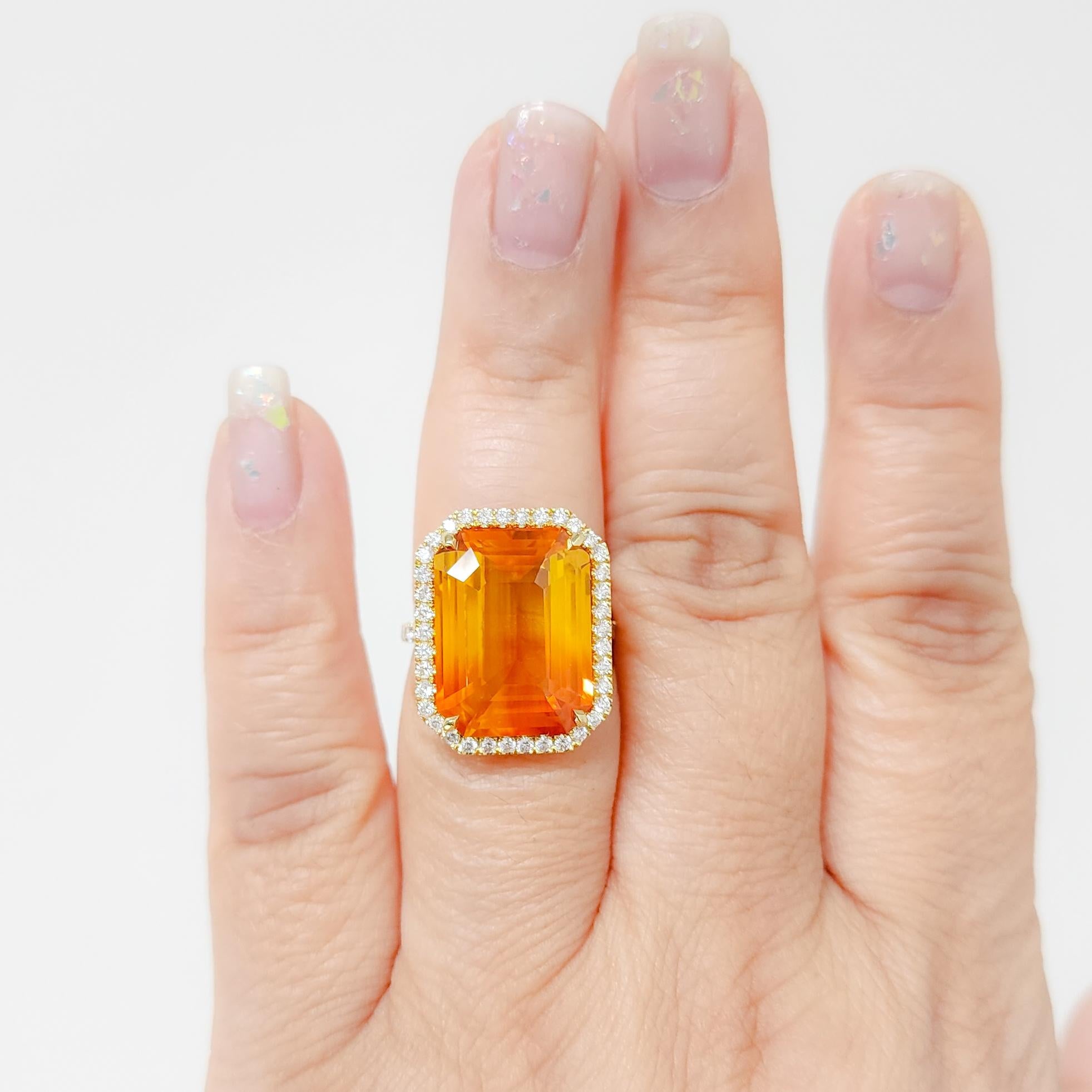 Gorgeous bright 18.05 ct. yellowish orange sapphire emerald cut with 0.79 ct. good quality white diamond rounds.  Handmade in 18k yellow gold.  Ring size 6.5.  GIA certificate included.