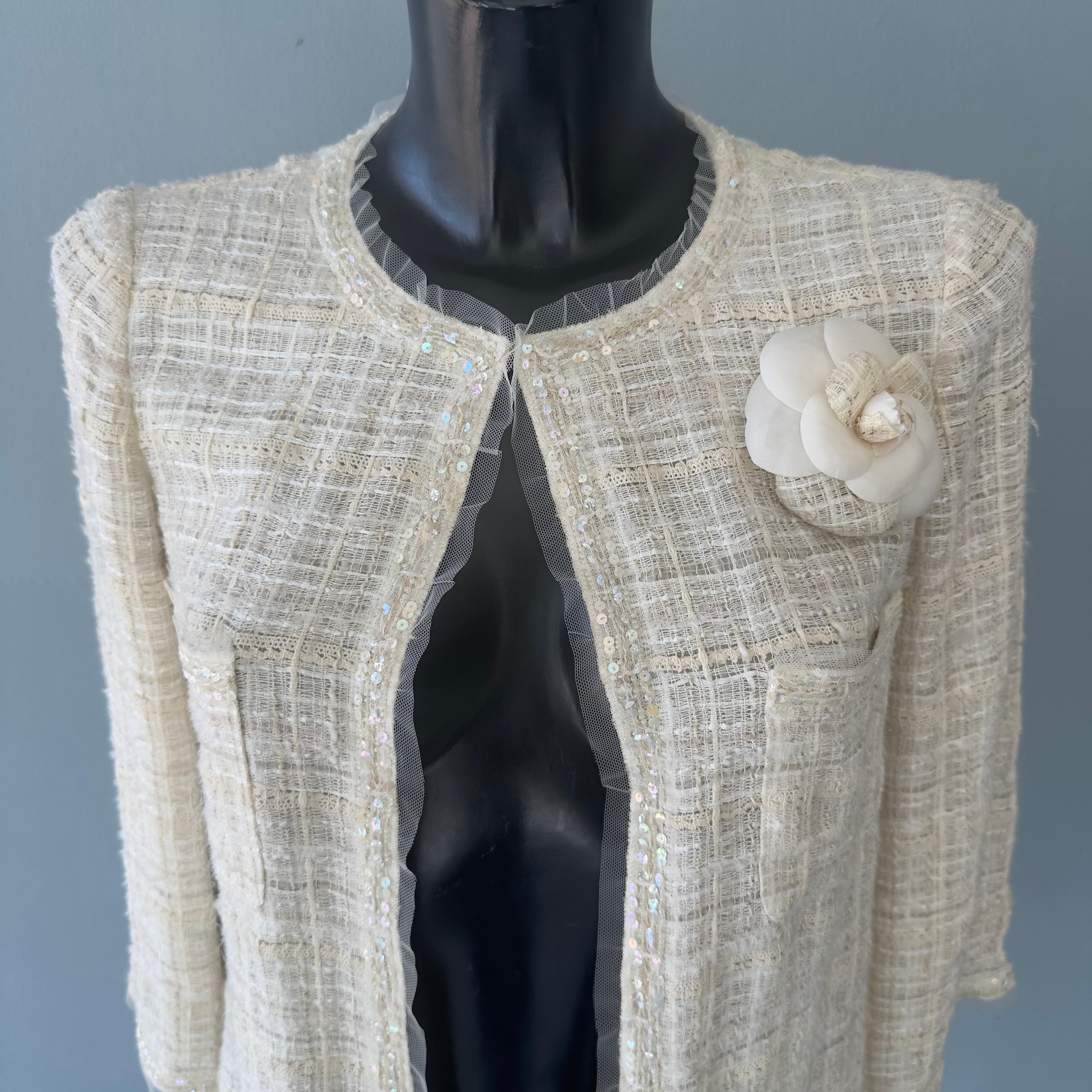 Chanel jacket worked with camellia brooch 3
