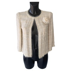 Chanel jacket worked with camellia brooch