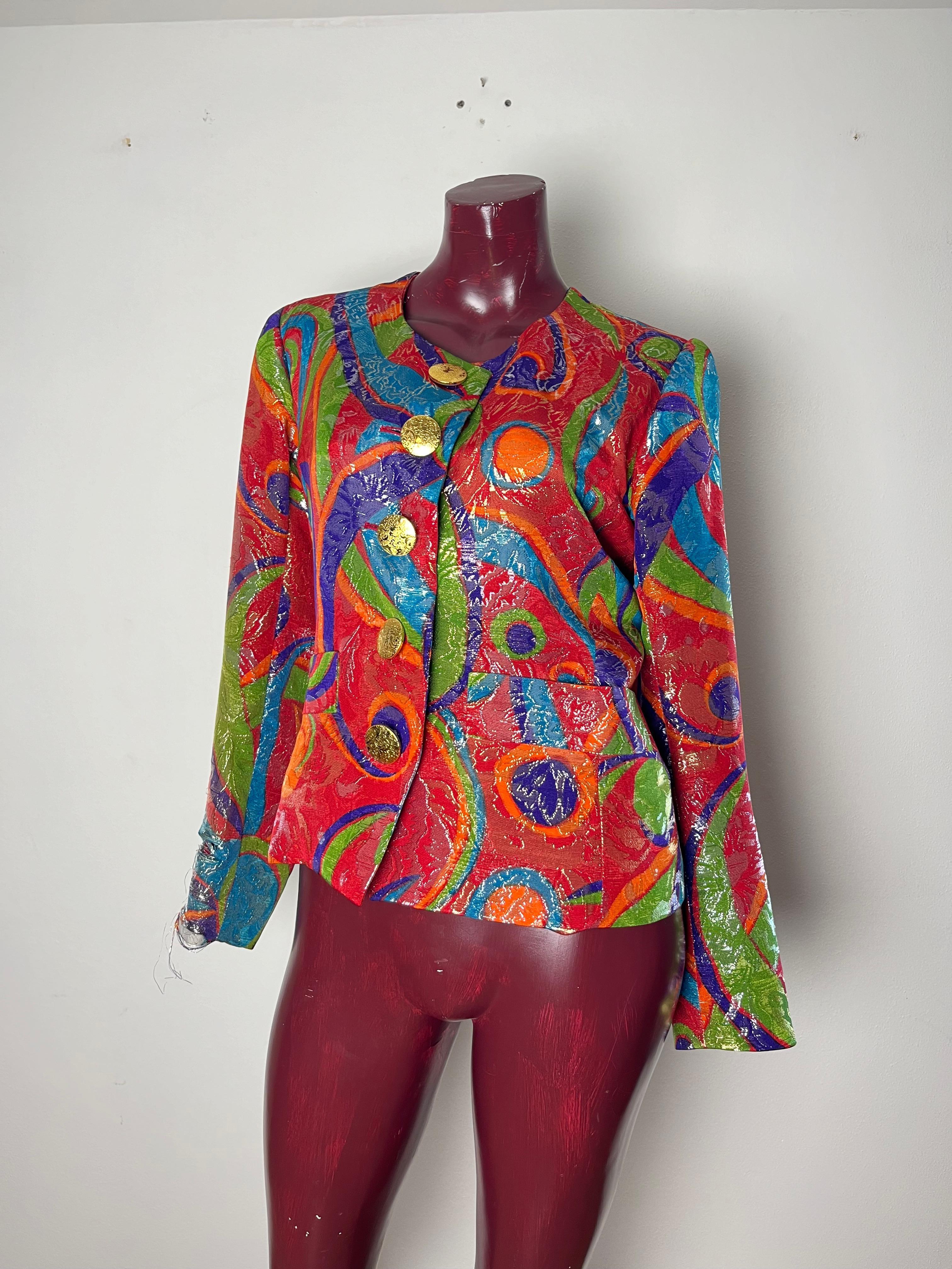 Evening multicolor brocade single breasted jacket.  1980s Fabric composition: 51% wool, 34% silk, 15% wire. Red silk lining. Gold metal buttons on the front and 5 buttons on each sleeve
we sell at a discounted price as it has a fairly major defect