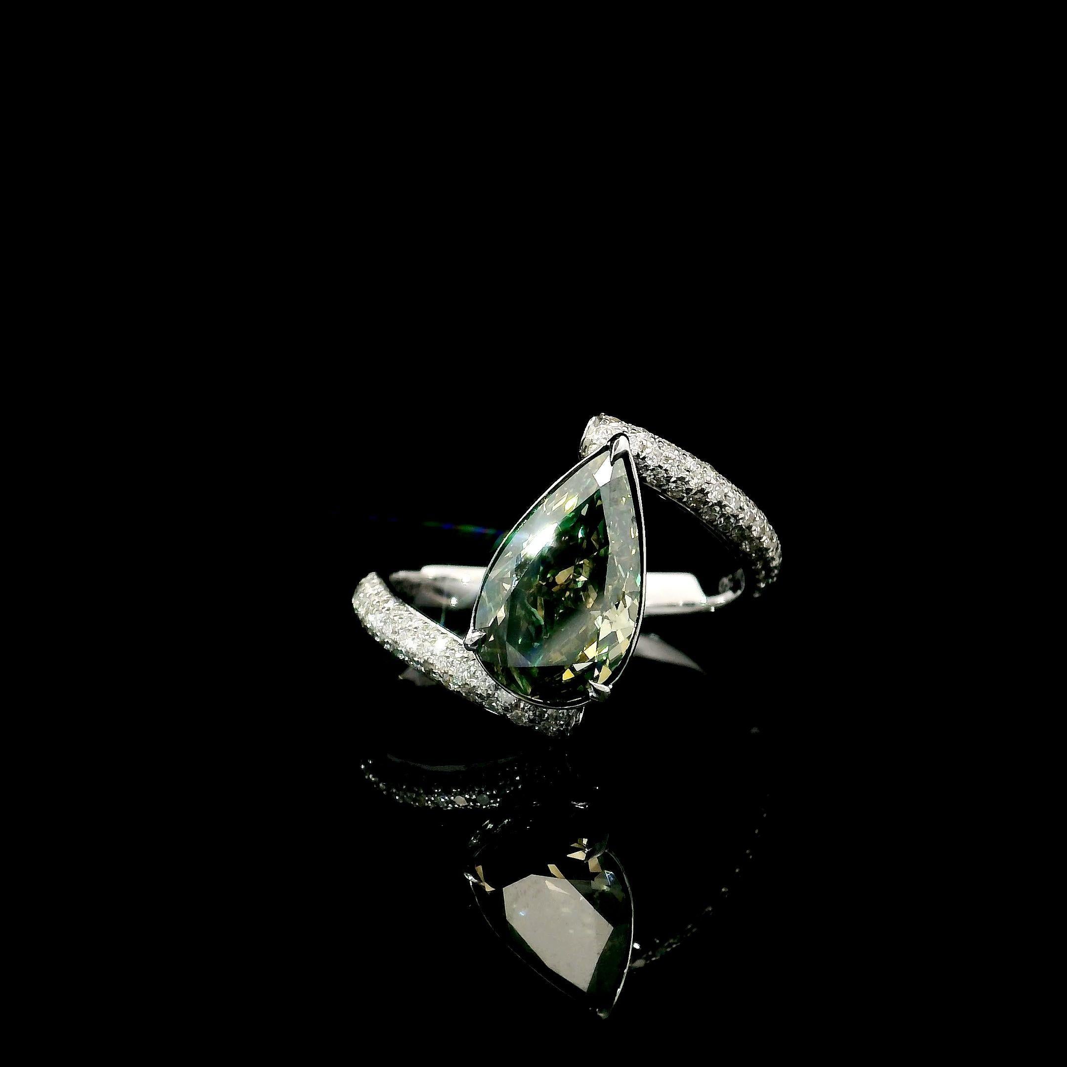 18kt white gold ring with diamonds
  
  Gold colour & karat: White gold 18kt
  Weight: 3.75 grams
  
  Set with-
  Stone type: Diamonds
  Shape: Pear
  Carat: 2.17
  Colour: Fancy Dark Gray Yellowish Green
  Clarity: SI1
  
  Surrounding Stones: