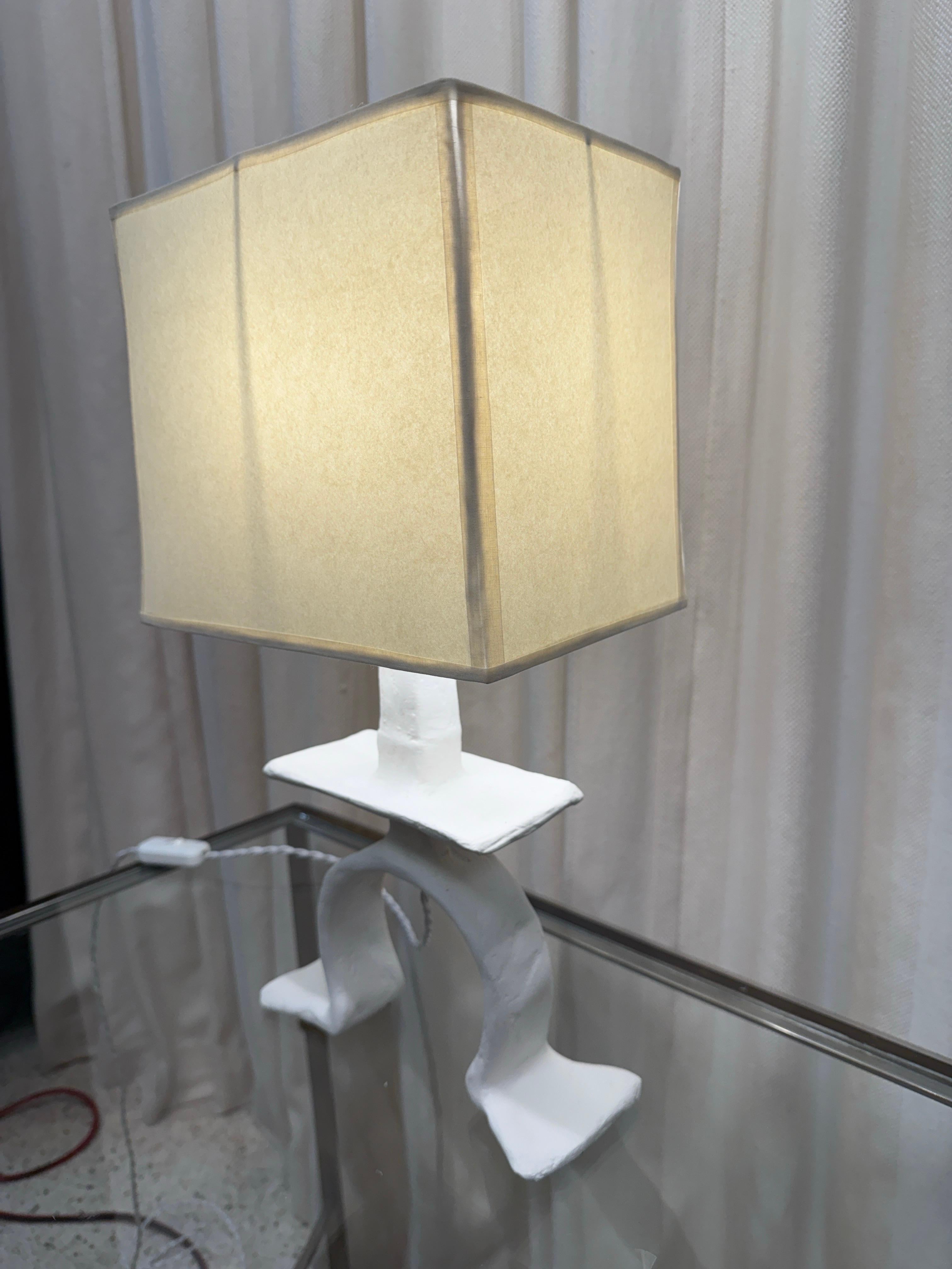 A beautiful textured French plaster over metal table lamp with tribal design base and NEW custom paper shade, new silk wiring.