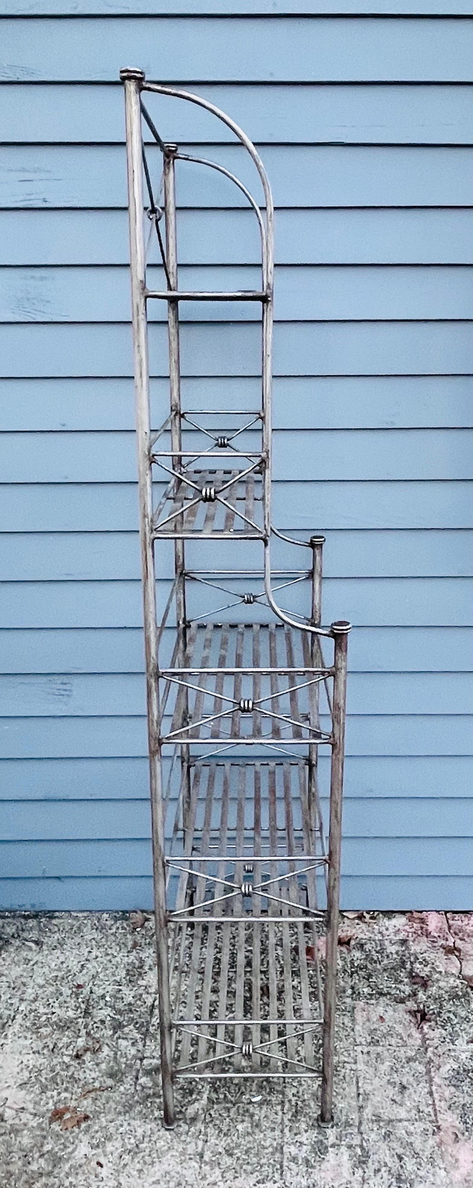 Giacometti inspired wrought iron Bakers Rack

Available now and ready to ship. 
This piece is in excellent condition and has spent its decades inside. Suitable for indoor/outdoor use.

Classic Diego Giacometti design featuring 5 shelves. A perfect