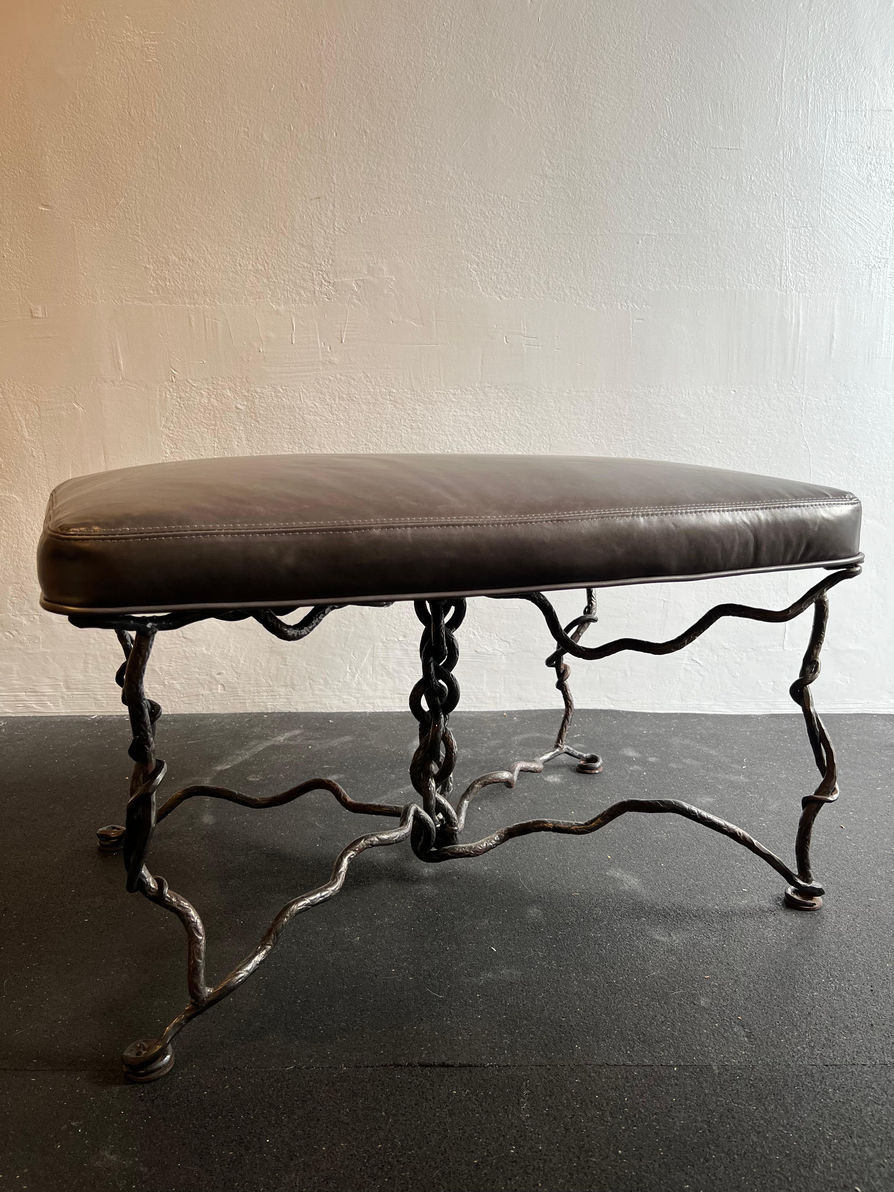 Giacometti style brutalist iron bench with leather upholstery. The top has been reupholstered in a heavy grade distressed leather. Base shows wear consistent with age. (please refer to photos). Additional photos available upon request.

Would work