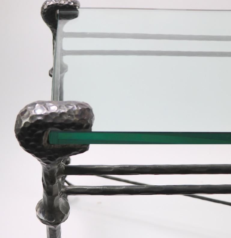 Stylish console table after in the style of Giacometti - Wrought iron base having a faux hammered surface, supports the original thick plate glass top surface (.75). Unusual to find the console table form non the market, most often the coffee tables