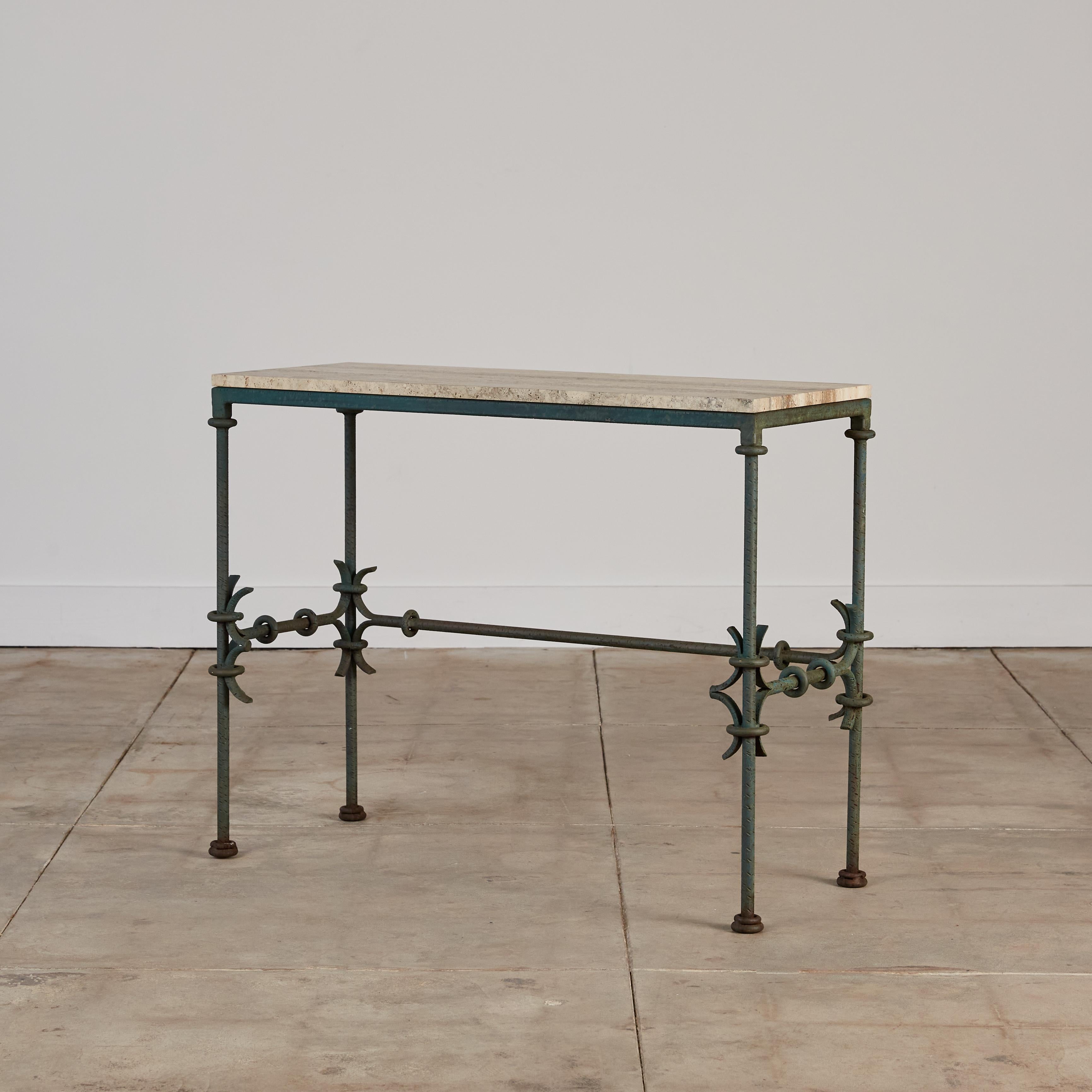 This wrought iron console table with an exquisite patina features a travertine top with beautiful veining and masterful metalwork. The base is decorated with stylized round design elements that wrap around the legs. The way the metal curves is
