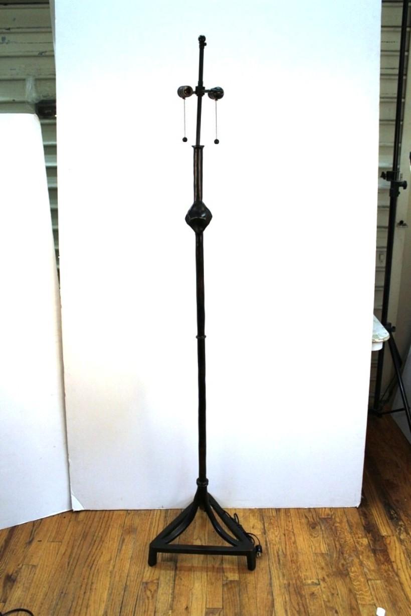 Giacometti style floor lamp designed in heavy ebonized bronze on a tripod base with ornamental nobs reminiscent of the style of Giacometti. The piece is in very good vintage condition with age-appropriate wear.