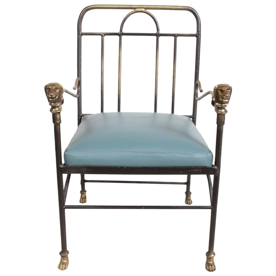 Alberto & Diego Giacometti style armchair with lion heads on arms and lion paws as feet, bronze fittings with iron frame and new blue leather seat. 

Measures: 35.3/8 H x 22 W x 23.25 D, seat 18.