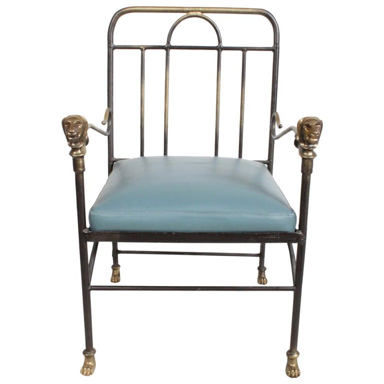 Alberto & Diego Giacometti style armchair with lion heads on arms and lion paws as feet, bronze fittings with iron frame and new blue leather seat. 

Measures: 35.3/8 H x 22 W x 23.25 D, seat 18.