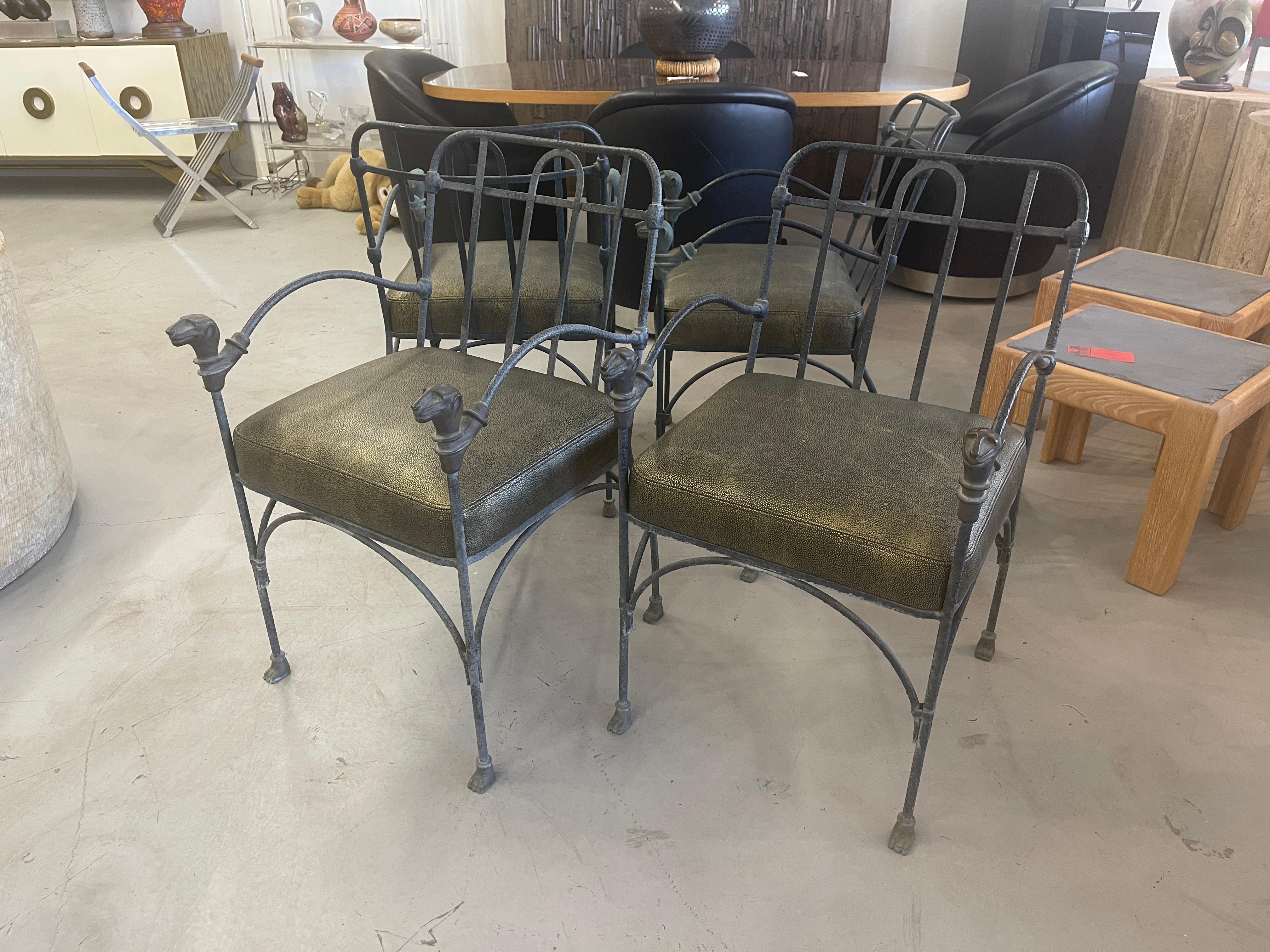 Wonderful set of 4 chairs by J Art Iron works in the style of Giacometti. These vintage chairs have bronze lion head and paw feet details and are made of iron. Each bear the J Art tag. We have had new seats made and upholstered them in Edelman
