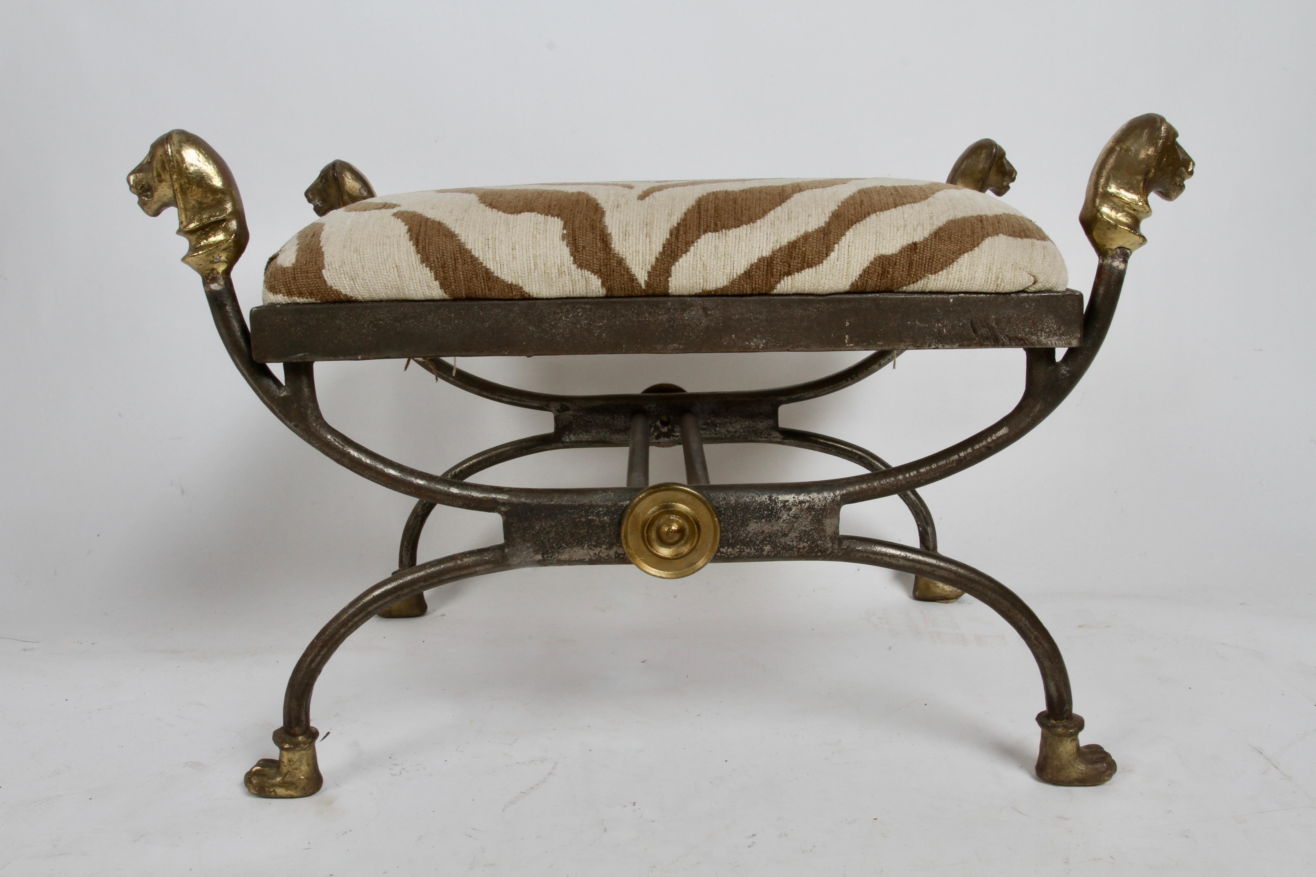 1970s Alberto & Diego Giacometti style classic X form ottoman with lion heads and paw feet, bronze fittings on heavy iron frame faux upholstered zebra seat. In very fine original condition, foam and upholstery are fine. 
