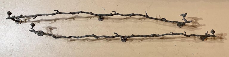A wonderful pair of Giacometti style naturalistic patinated bronze wall branch sculptures of faux bois with bird motifs. These organically rendered branches with birds perched are an asymmetrically designed pair, in the manner of well known Swiss