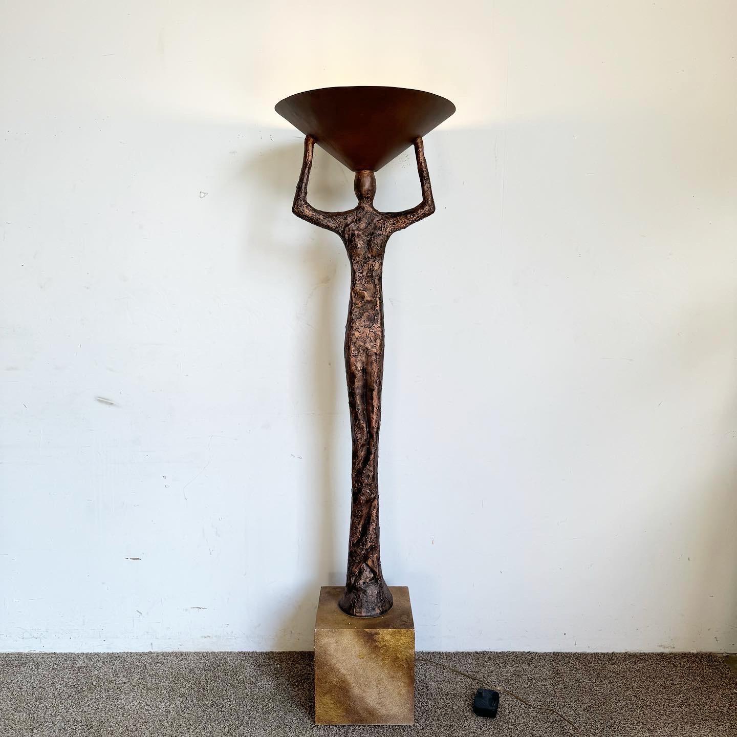 The Giacometti Style Sculpture Floor Lamp Torchiere is a blend of art and illumination. Inspired by Giacometti's iconic style, it features a slender, sculptural figure on a cubist block, holding a lamp shade. This torchiere design provides a warm,
