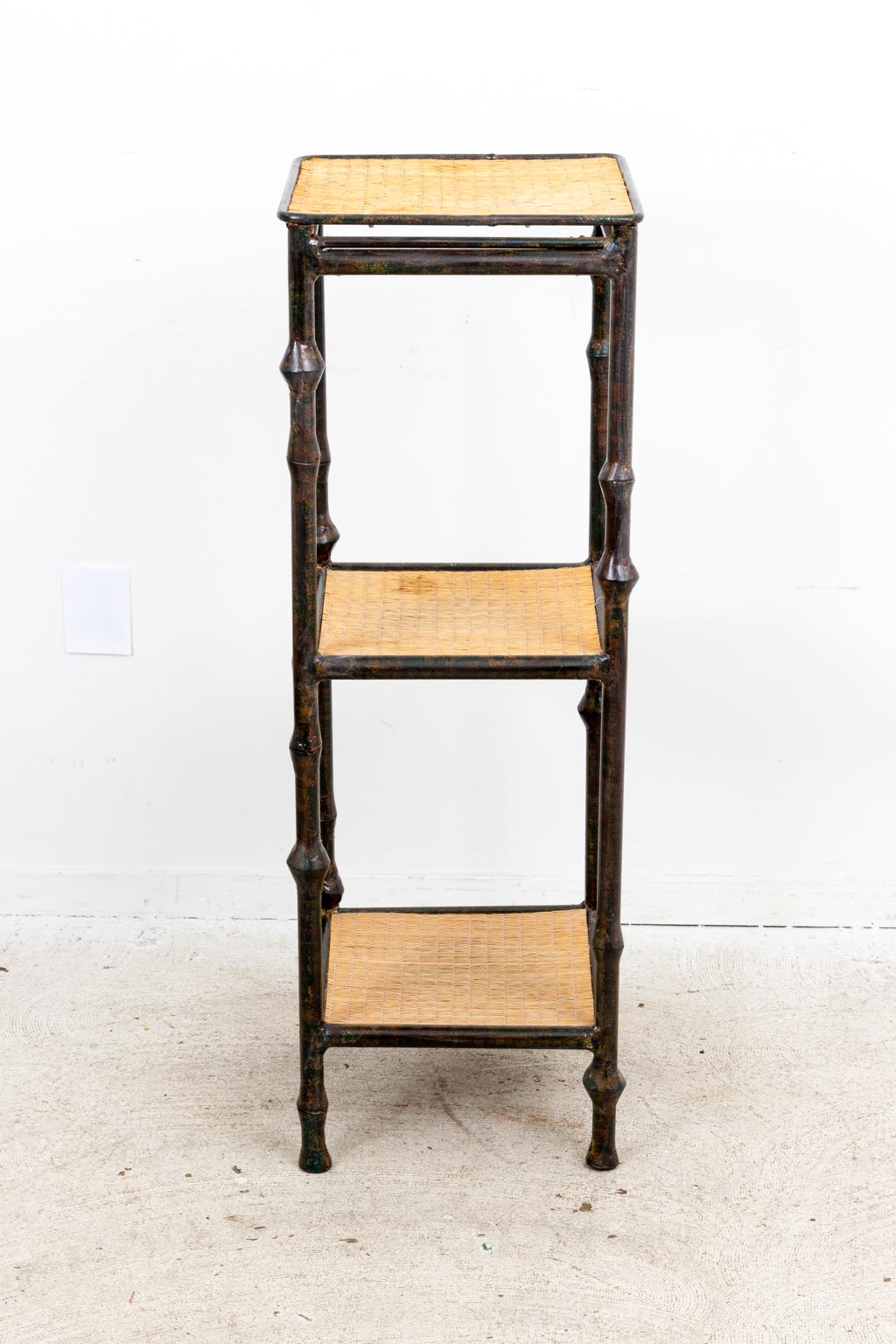 Circa 1990s Giacometti style three tier etagere with iron frame and grass top shelves. Please note of wear consistent with age.