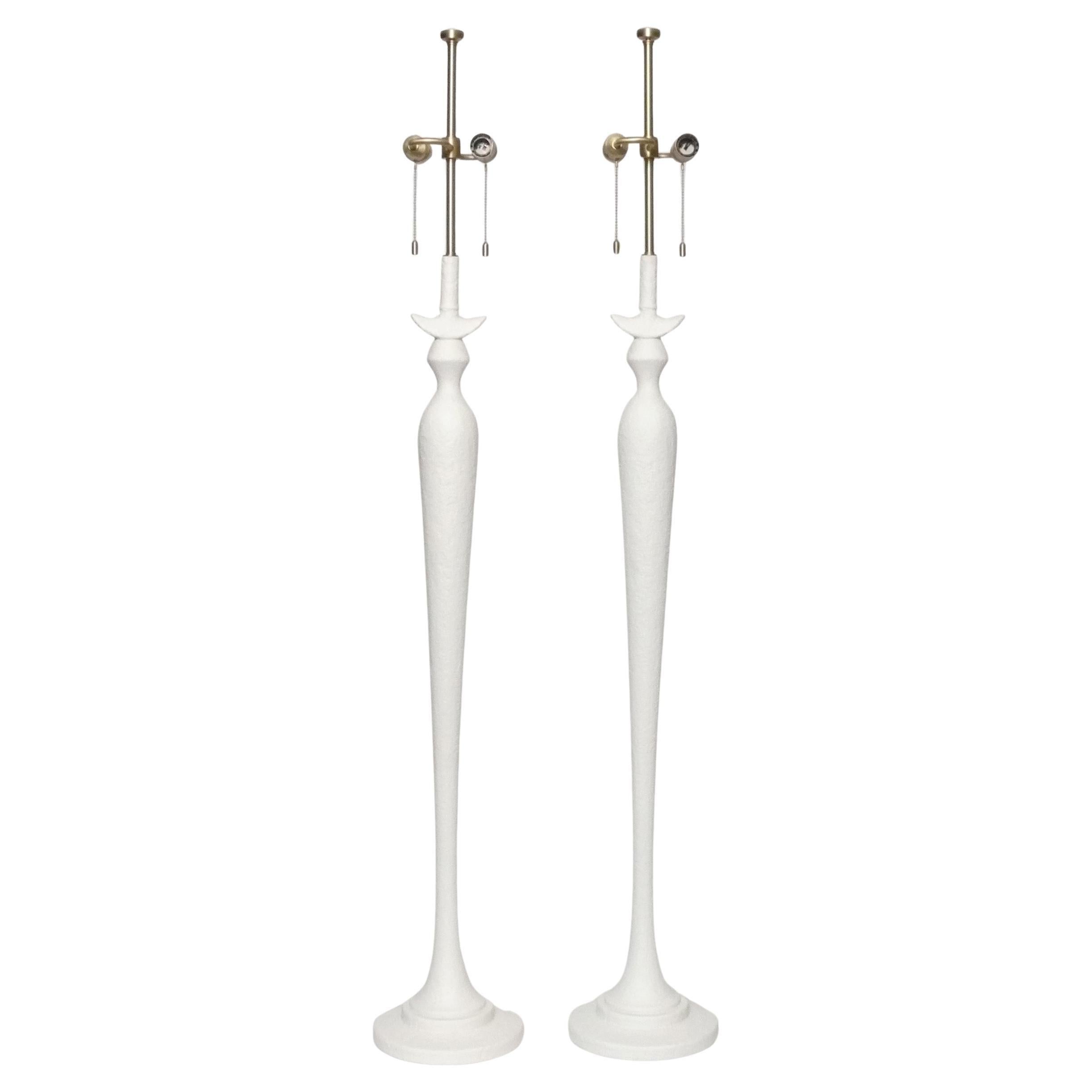 Pair of sculptural floor lamps, in the manner of Diego Giacometti, called the Firenze Model, by Baker Furniture, American, circa 2000s. They are constructed of a faux plaster and are a nice quality, like all Baker products. The lamp shades are not