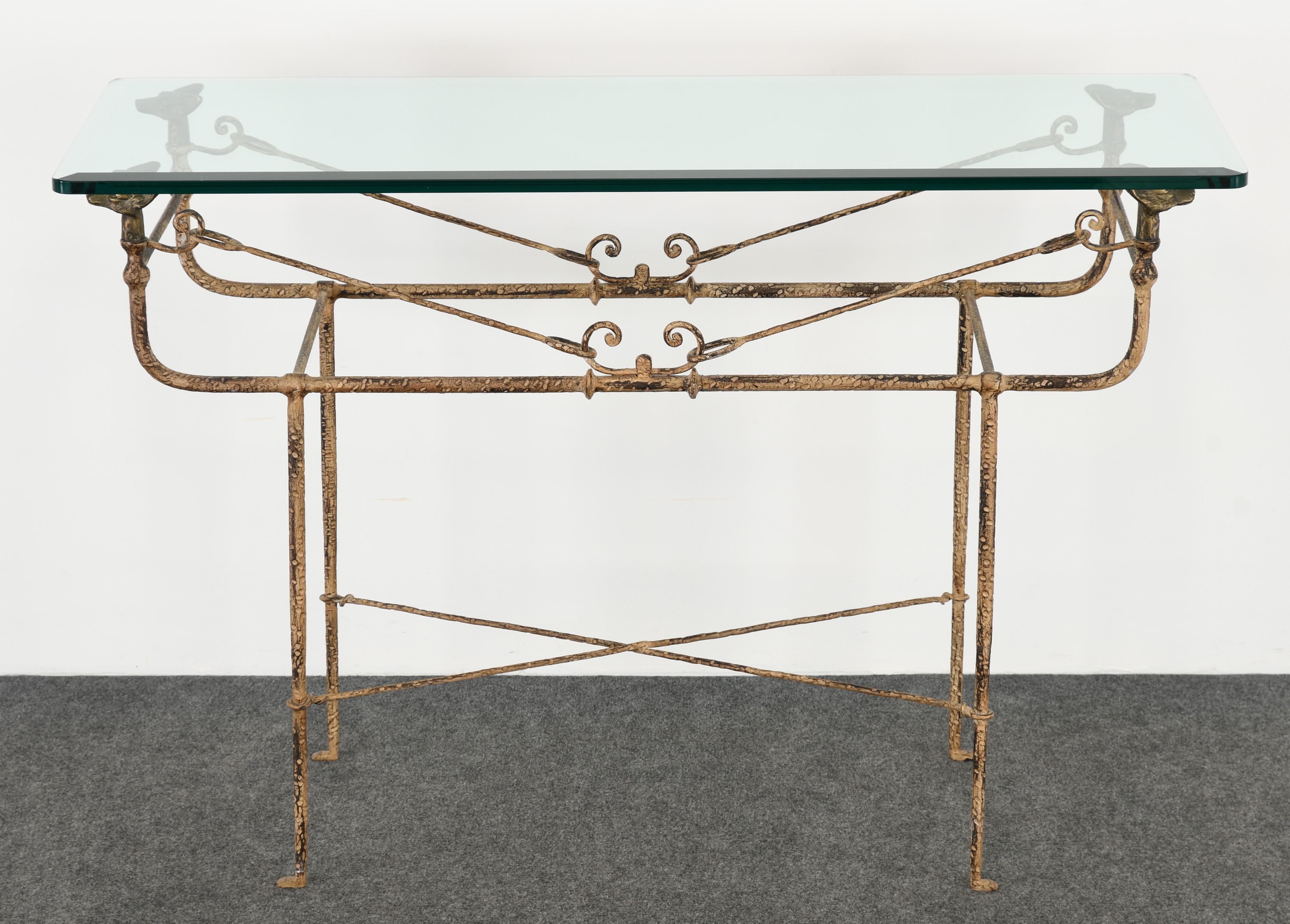 An impressive Giacometti style wrought iron and bronze console table by Paul Ferrante. This beautiful distressed painted table has a 3/4