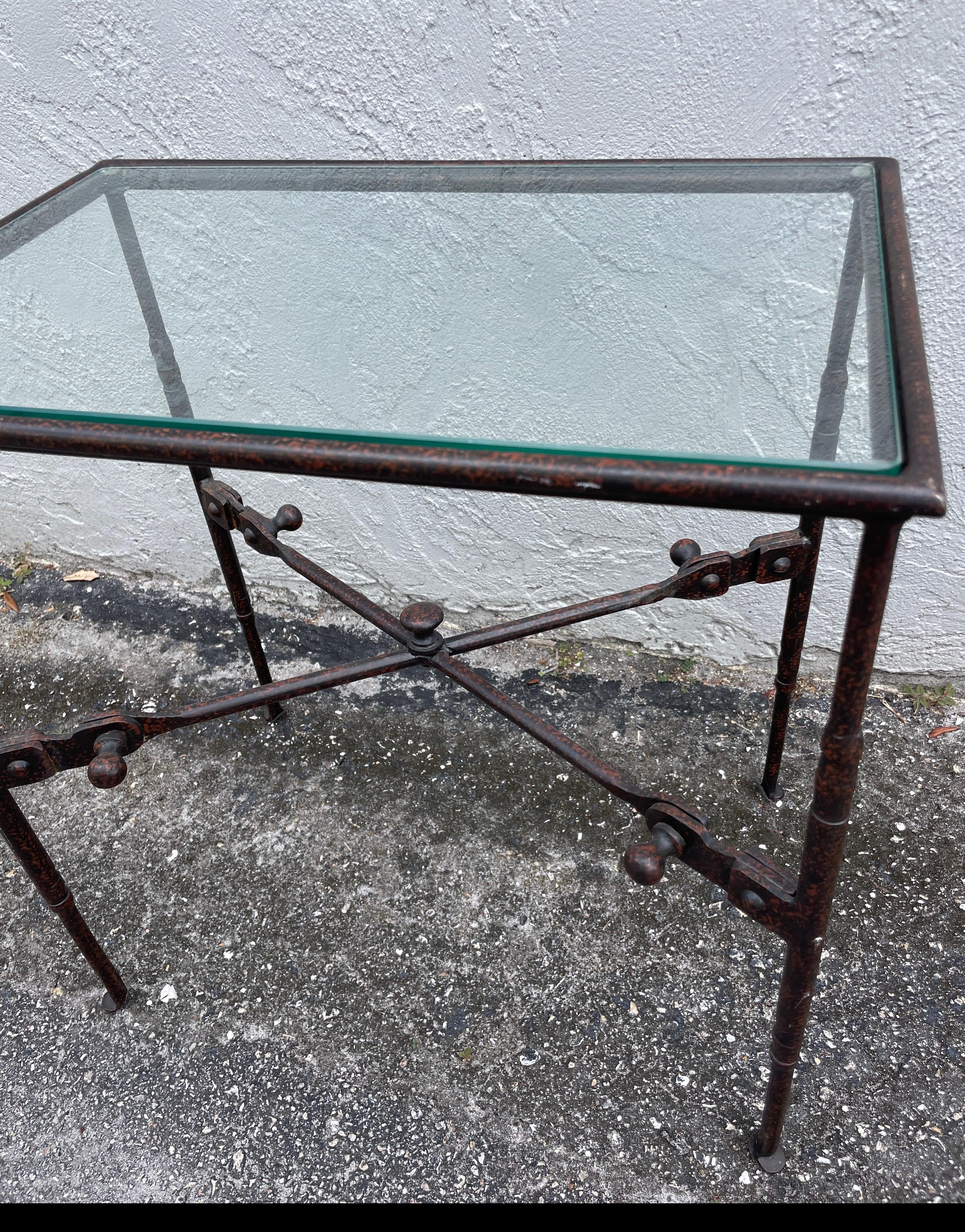Vintage wrought iron Giacometti style side table with glass top.