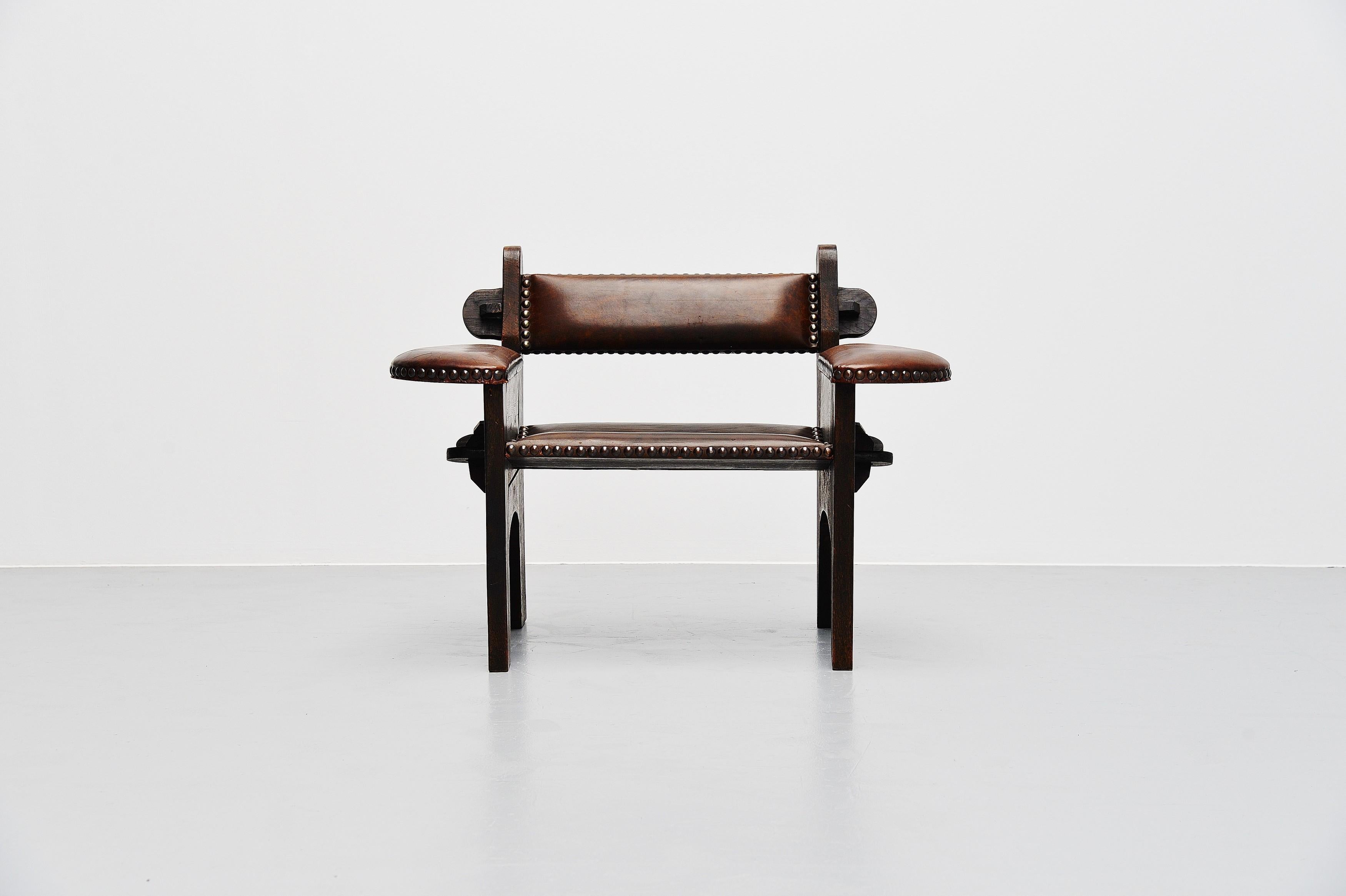 Stunning brutalist armchair attributed to Giacomo Balla, Italy, 1950s. This solid ash wooden chair has a super rough and yet elegant feel. It is dark stained and has a brown leather seat and back, finished with copper nails. The chair is not glued
