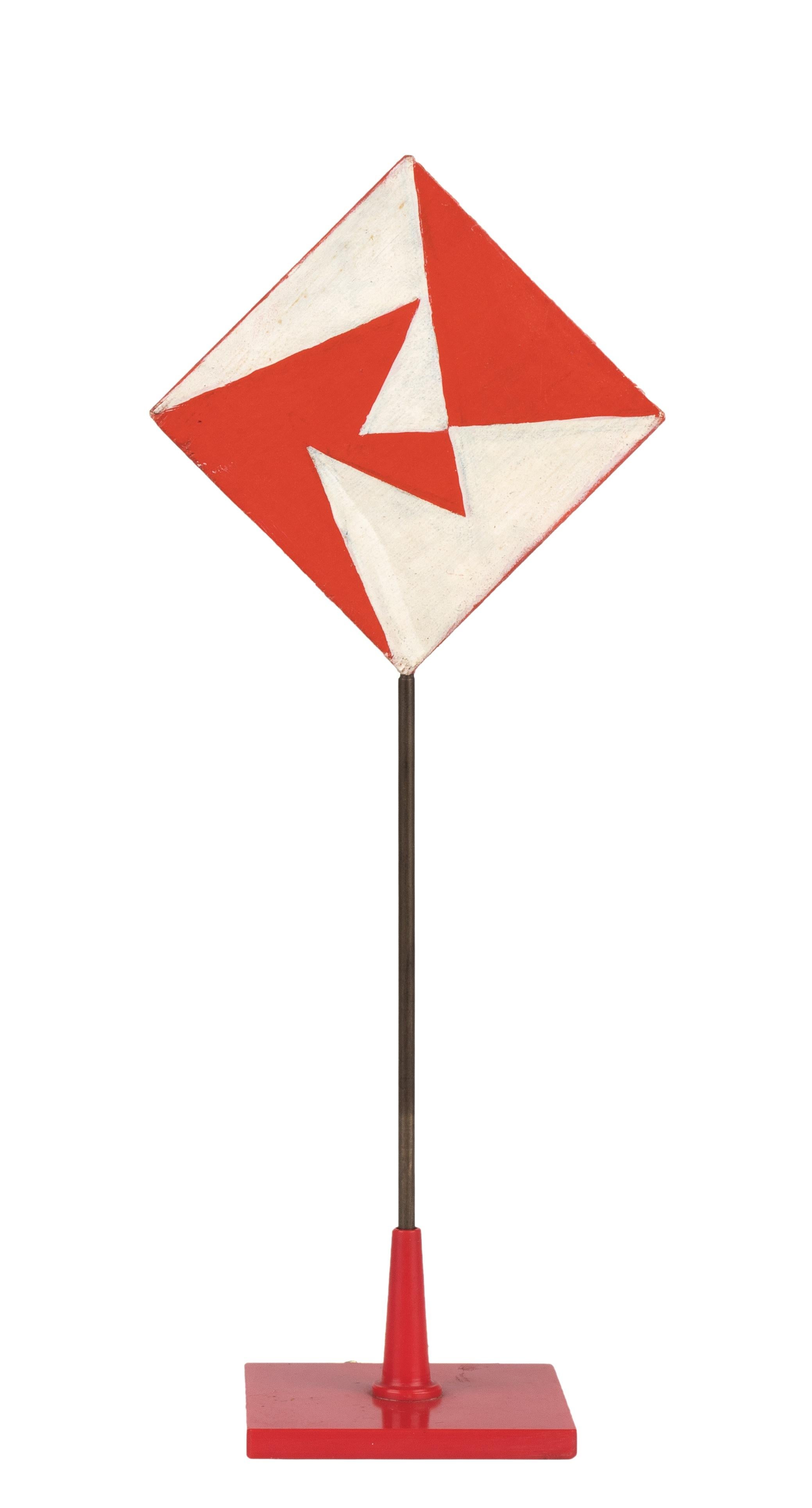 The 'Placeholder White and Red'  by Giacomo Balla (1871-1958), with white red space lines recto and geometric pattern with red and white triangles verso, realized in the 1930s.

Tempera on wood, aluminium structure and plastic base, 21,5 x 8,7 cm