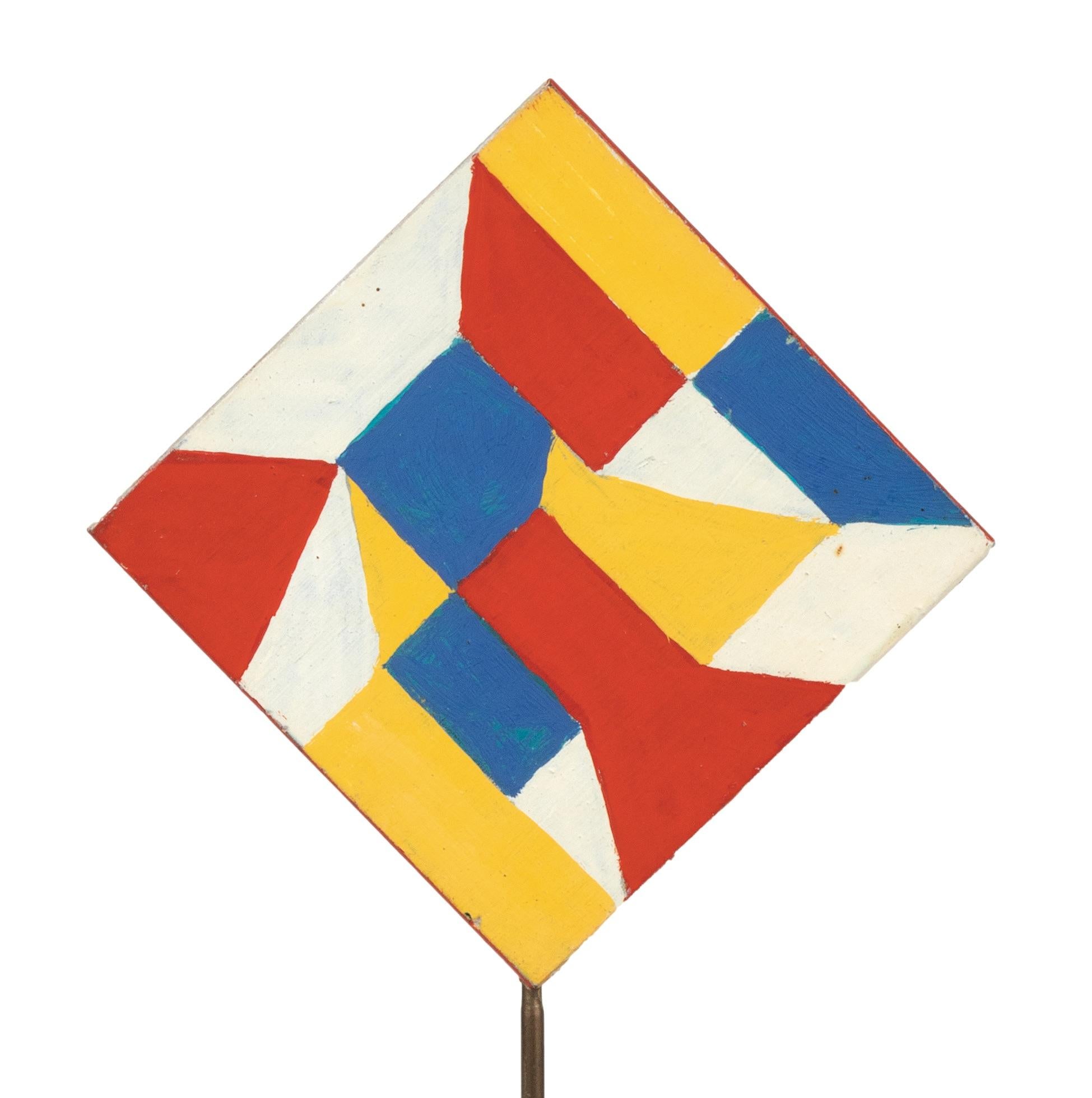 The 'Red and Blue Triangles'  by Giacomo Balla (1871-1958), with re, blue and yellow Shapes (verso) and red and blue triangles(recto), realized in the 1930s.

Tempera on wood, aluminium structure and plastic base, 20 x 11 cm (21,5 x 11 cm with the