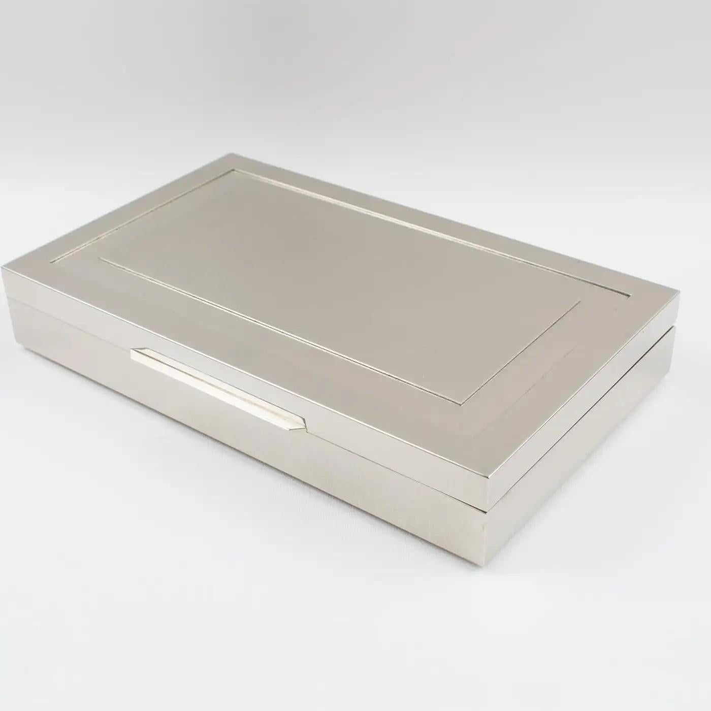 This exquisite modernist decorative covered box was designed by Giacomo Sinopoli and crafted by Liwan's Rome in the 1970s. The box features a large rectangular shape in chromed metal with a satin finish aspect and a geometric design on the lid. The
