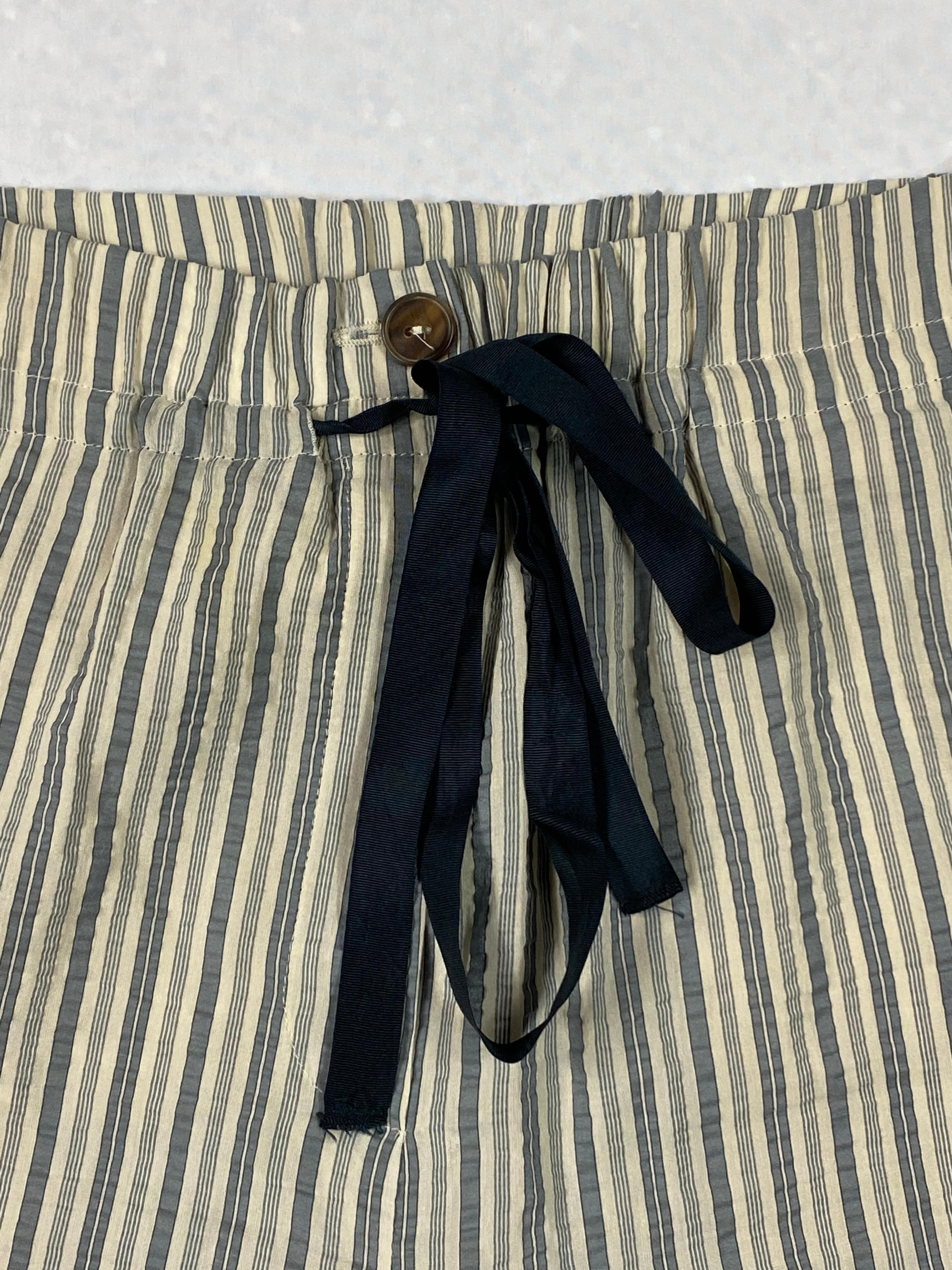 Product details:

The pants feature straight fit, very lightweight fabric with vertical striped pattern, front bow ribbon detail. Made in Italy.

