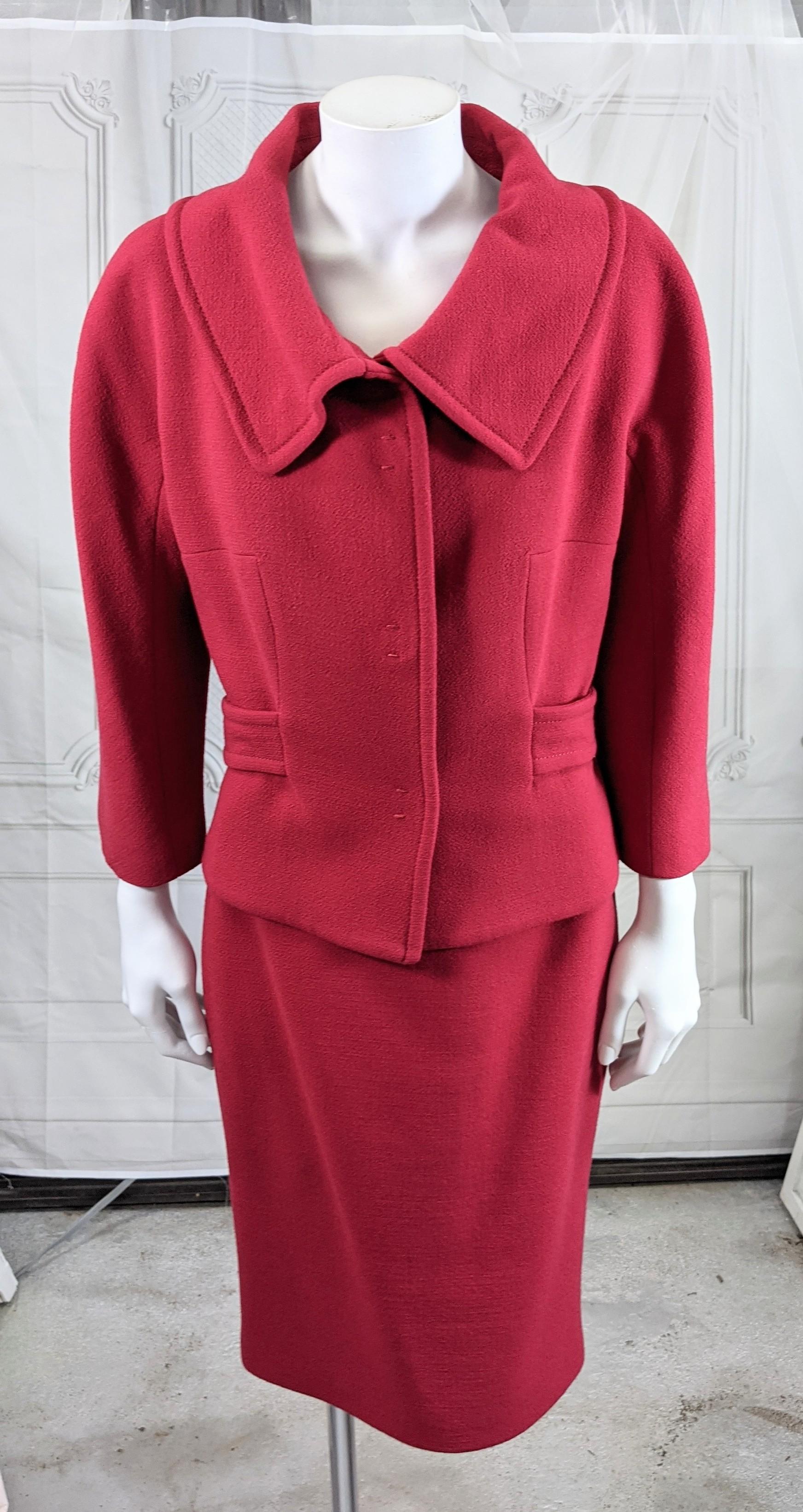 Elegant Giambatista Valli Rasberry Wool Crepe Suit in the Balenciaga style with open neck collar and half belt design on back. 3 large black snap closures and cropped sleeves. Matching slim skirt has knit trimmed waistband and back zip