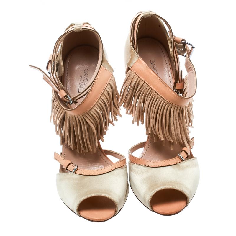 Wear these stylish sandals from the house of Giambattista Valli and channel your inner fashionista. They feature buckle straps, fringes and high heels. Lined with leather, the sandals will keep you at the top of your style game.

Includes: The
