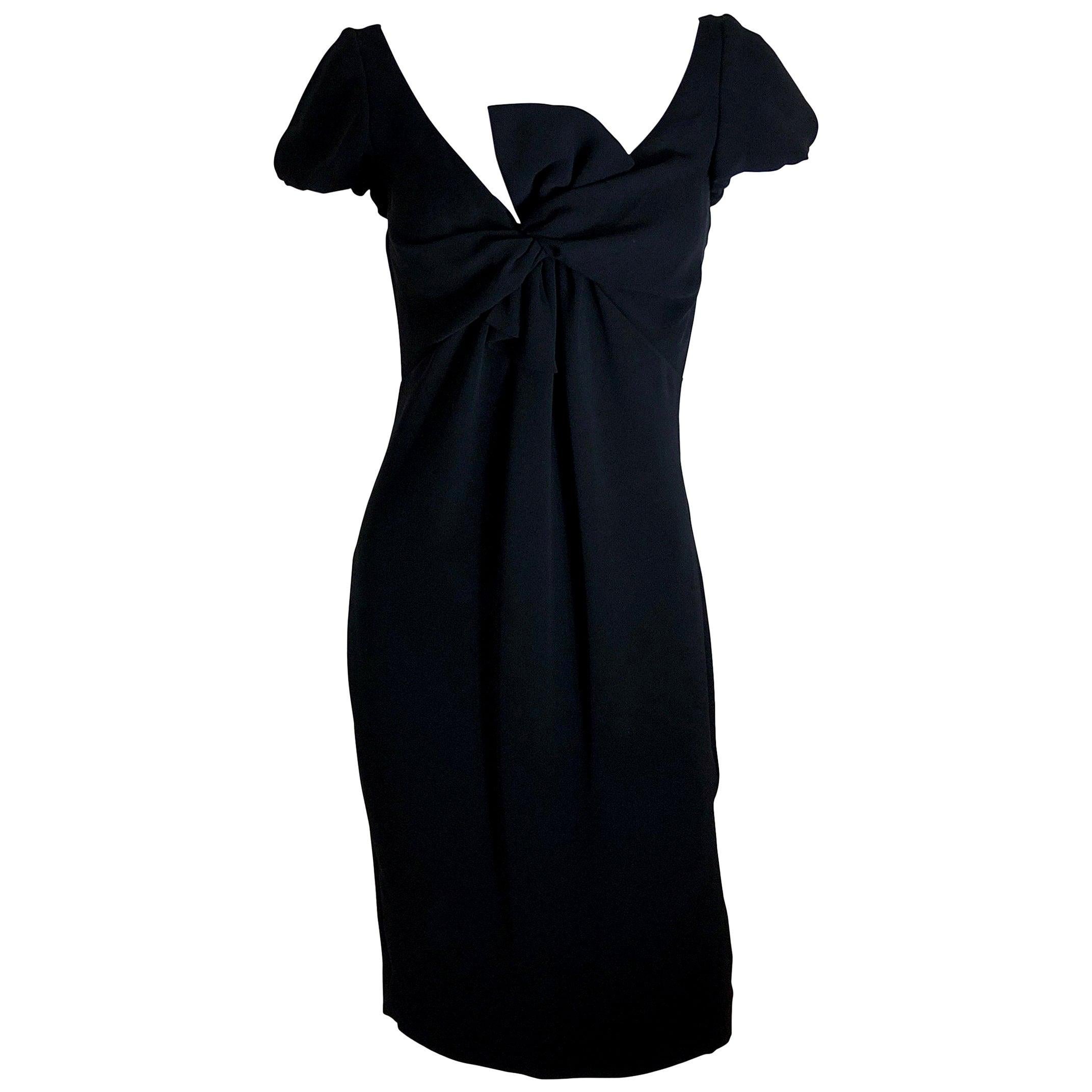 Make:  Giambattista Valli
Place of Manufacture:  Italy
Size:  42/S
Color:  Black
Condition:  One once.  Almost new.
Style:  Black cocktail dress of soft sueded silk with plunging neckline framed by a faux loos black bow and princess sleeve.  Dress