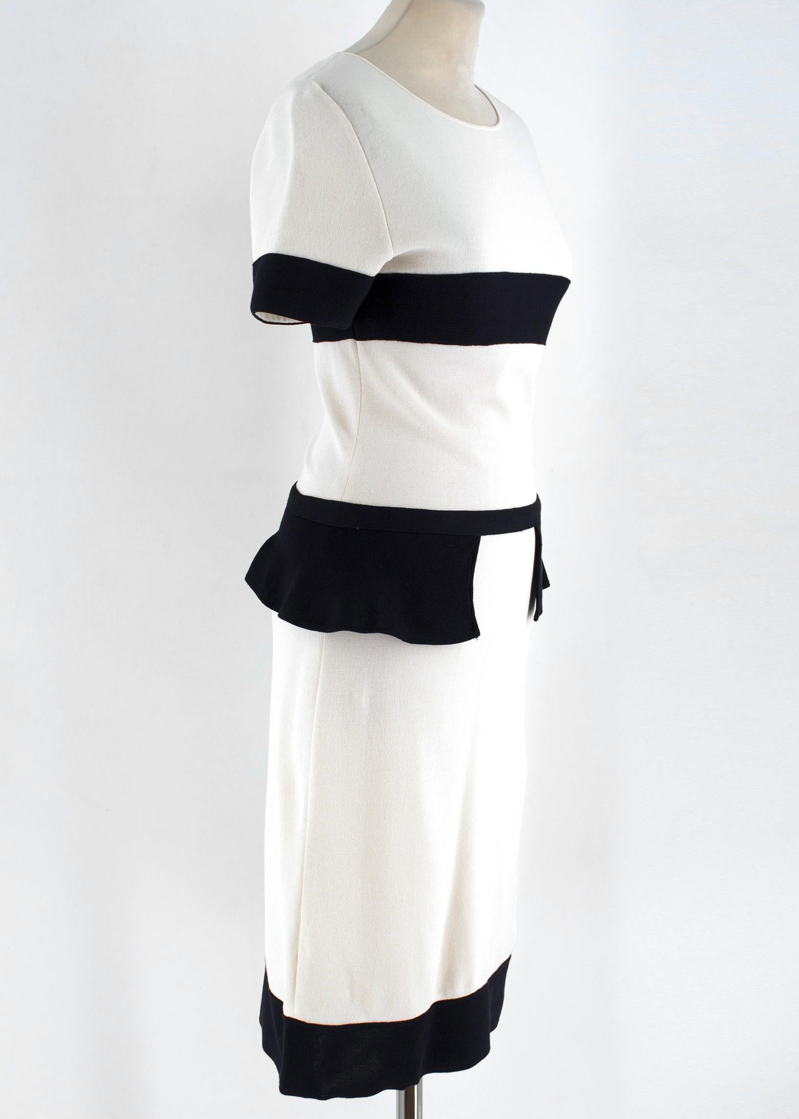Giambattista Valli Ivory Peplum Dress

-Ivory dress with contrast black detailing
-Knee length 
-Short sleeves
-Back zip closure
-Peplum waistband
-Black cuffs, hemline, waistband and stripe across the bust

Please note, these items are pre-owned