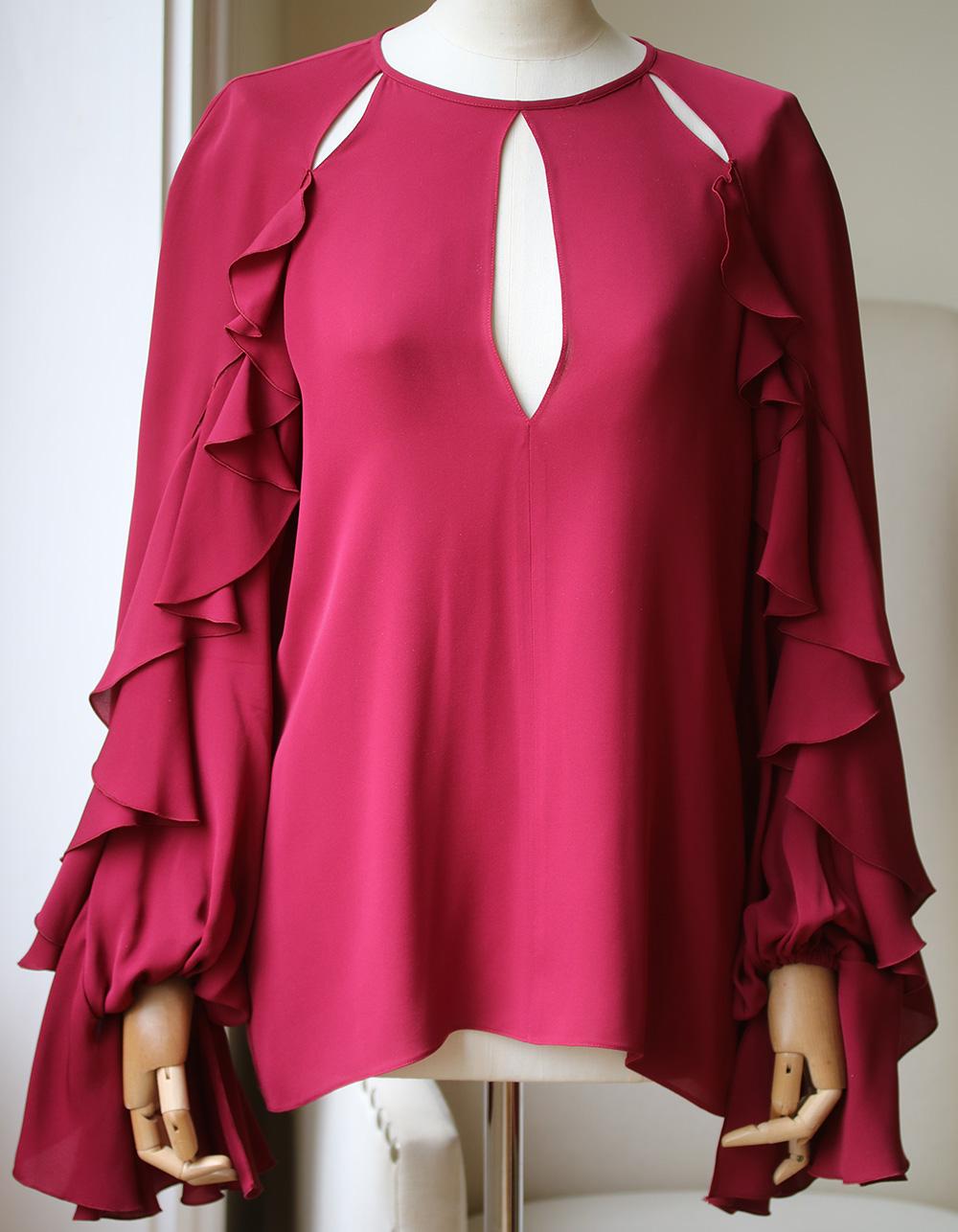 Giambattista Valli's top is made from luxuriously soft silk crepe de chine. It's decorated with ruffles along the sleeves and sleek cutouts at the shoulders and décolletage. Burgundy silk crepe de chine. Concealed hook and zip fastening at back.