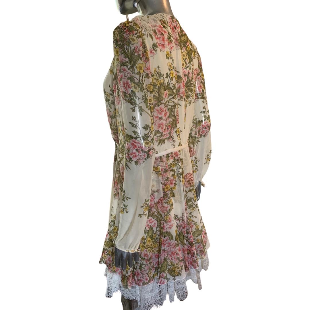 A very romantic dress designed by Giambattista Valli. From the runway collection show in Paris. Spectacularly made. Floral silk print with Imported white lace hem. Silk bow. Size tag removed. See measurements for details. Retailed for over $3500.