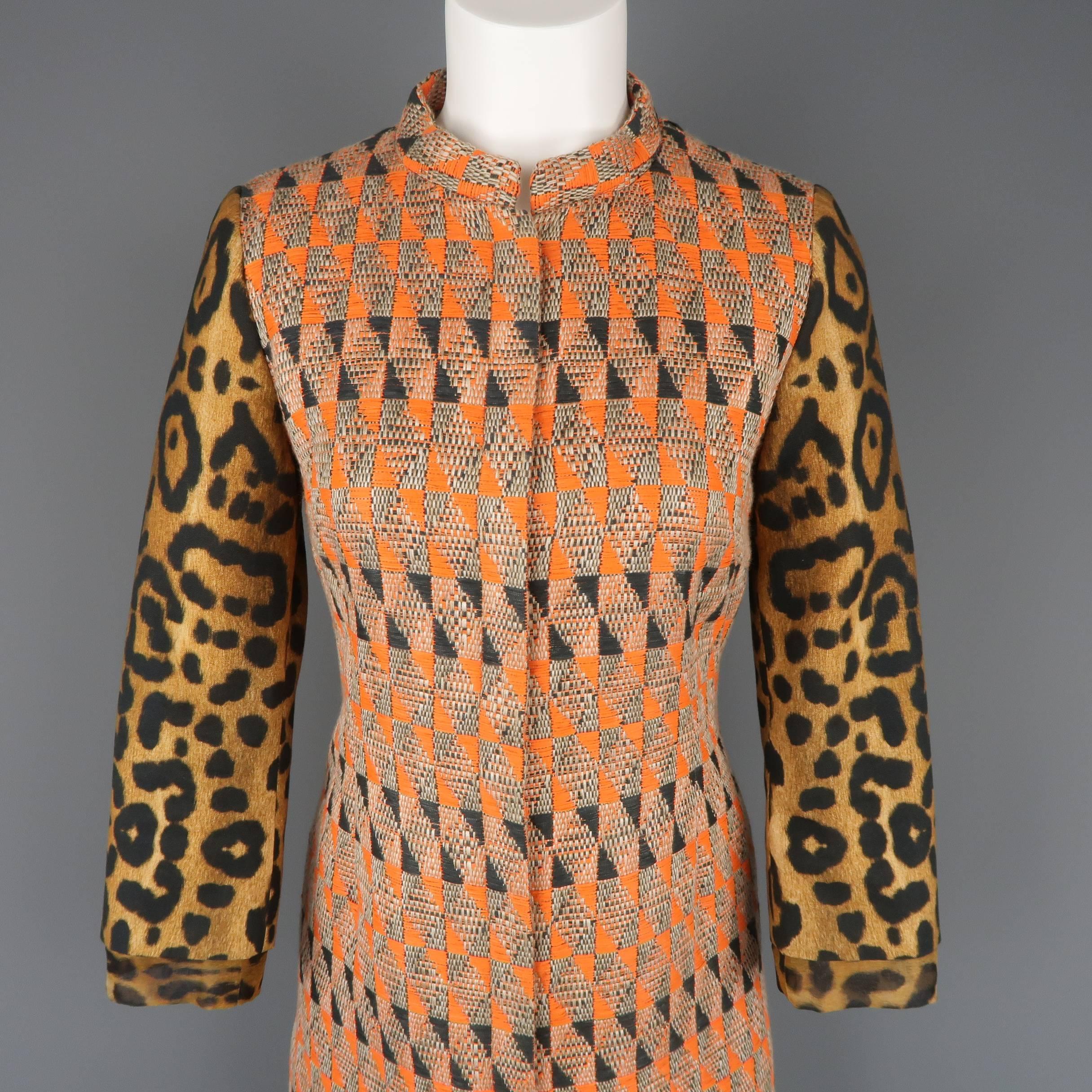 Giambattista Valli  cocktail dress features in an orange and tan geometric print body, band collar, hidden placket snap closure front, leopard print sleeves, and coral and clear rhinestone beaded trim with white ostrich feather hem. This piece is a