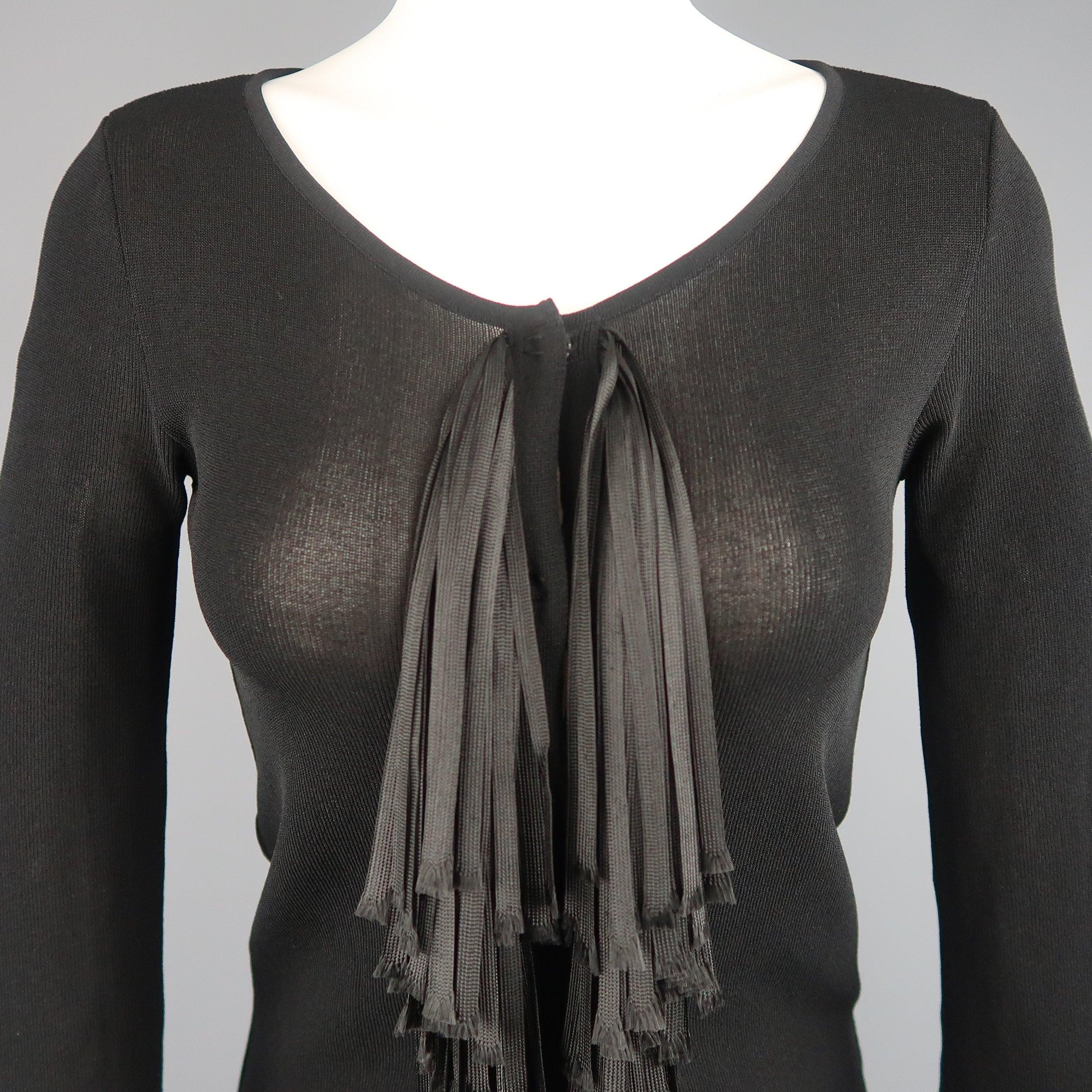 This GIAMBATTISTA VALLI cardigan comes in a sheer black knit and features a round scoop neck, three quarter sleeves, hidden placket snap closure front, and layered raw edge ribbon fringe down the front. Made In Italy.
Excellent Pre-Owned Condition.

