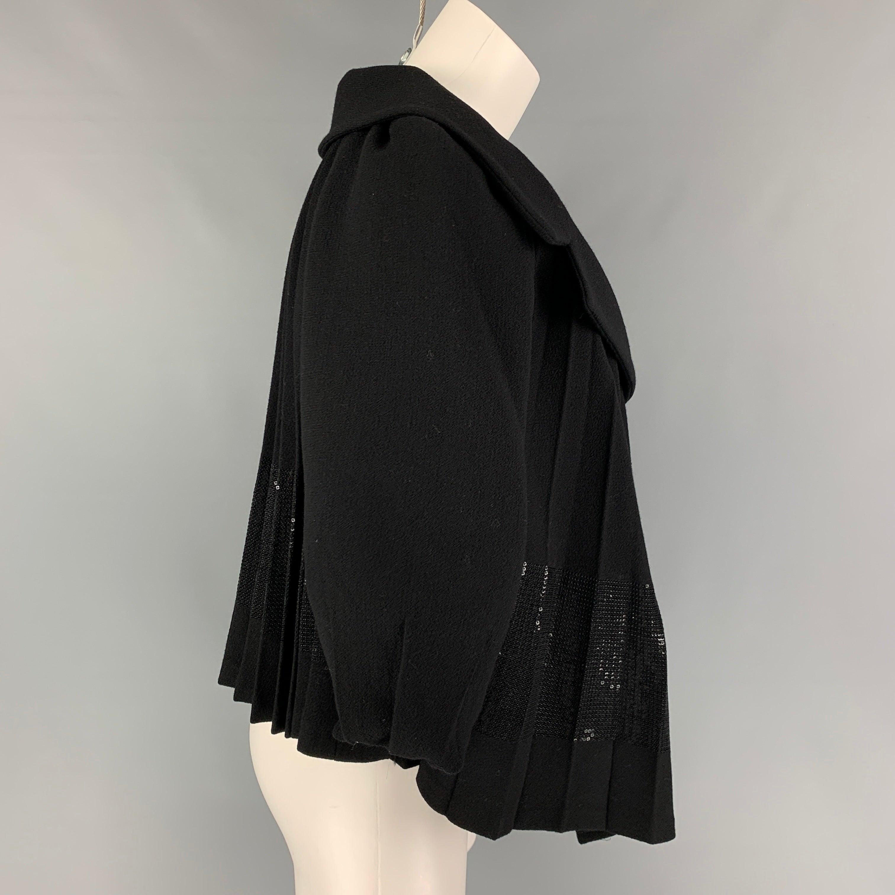 GIAMBATTISTA VALLI jacket comes in a black virgin wool featuring a pleated style, large notch lapel, sequined panel, and a snap button closure. Made in Italy.
Very Good
Pre-Owned Condition. 

Marked:   40/XS 

Measurements: 
 
Shoulder: 17 inches 