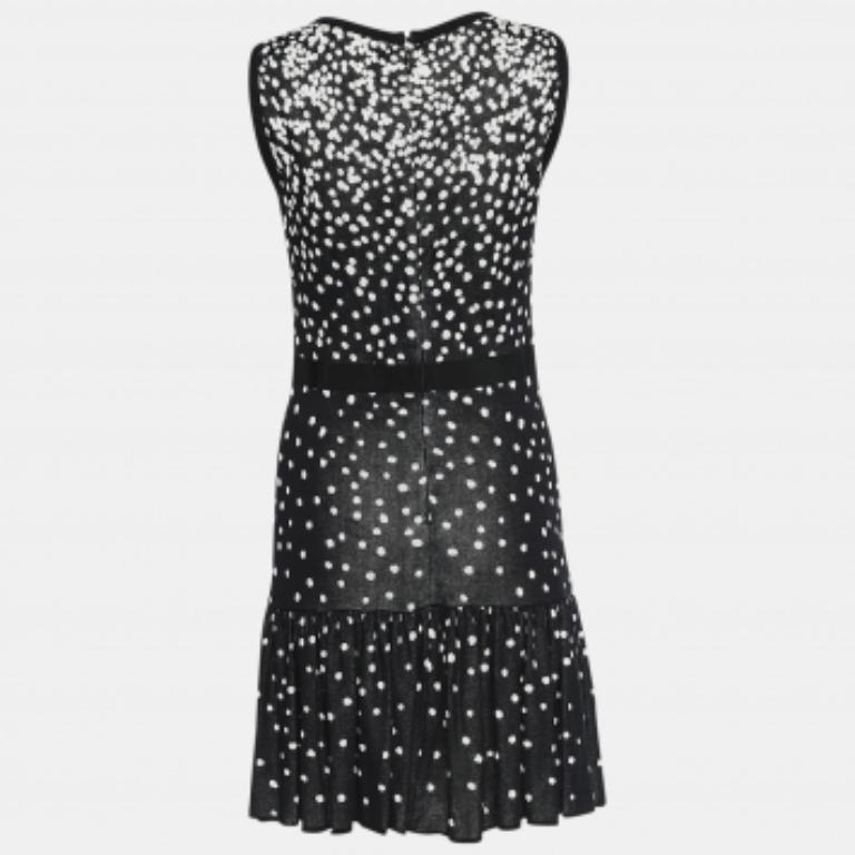 Beautiful tailoring and minimal details combine to form this sleeveless dress by Giambattista Valli. The dress is covered in polka dots, enhanced with a flared hem, and secured by a back zipper.