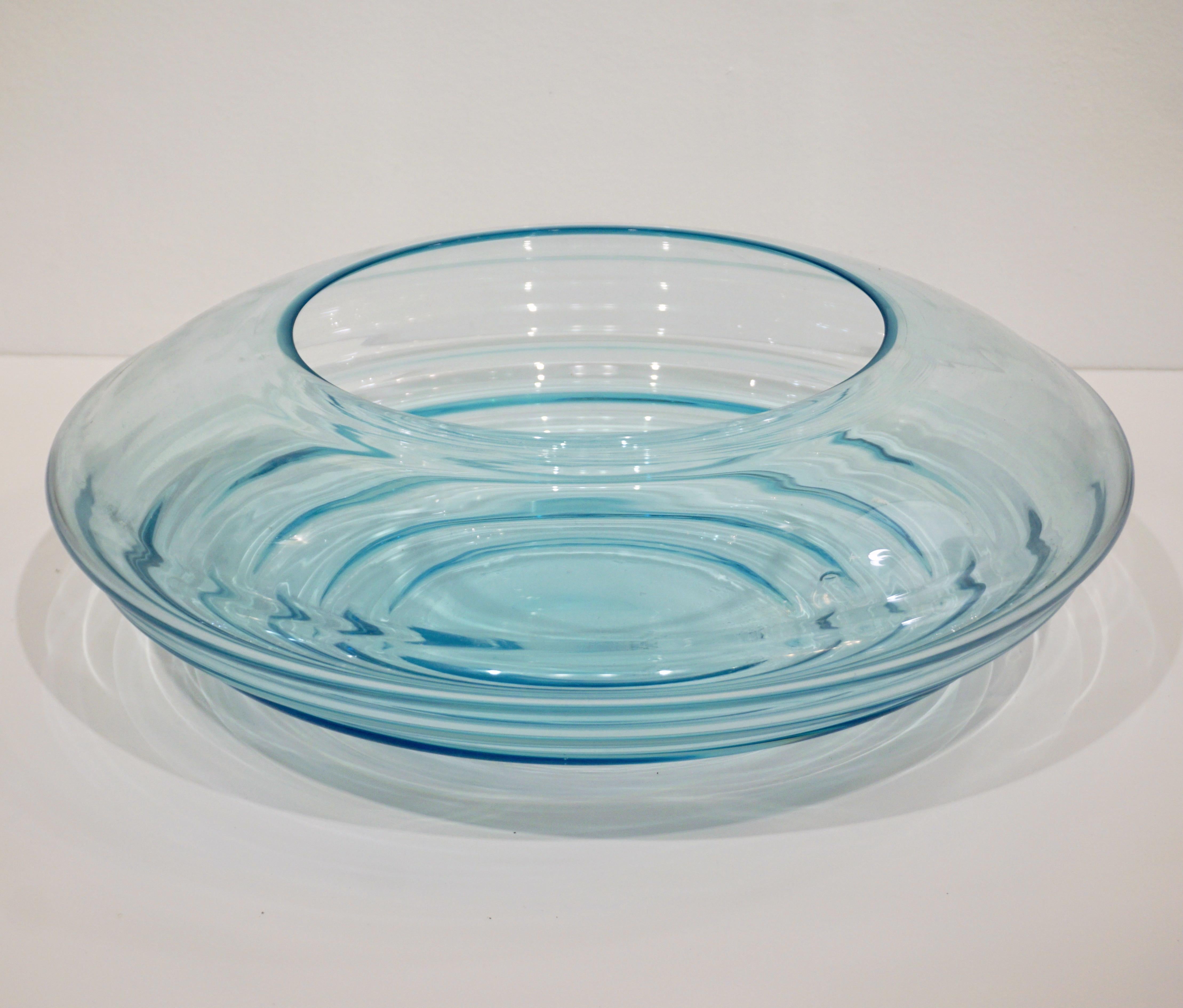 A signed Mid-Century Modern sensual curved centerpiece of great effect, blown in transparent crystal turquoise blue Murano glass, the ridges of the organic modern shape playing with the light create diverse intensities in color. High quality of