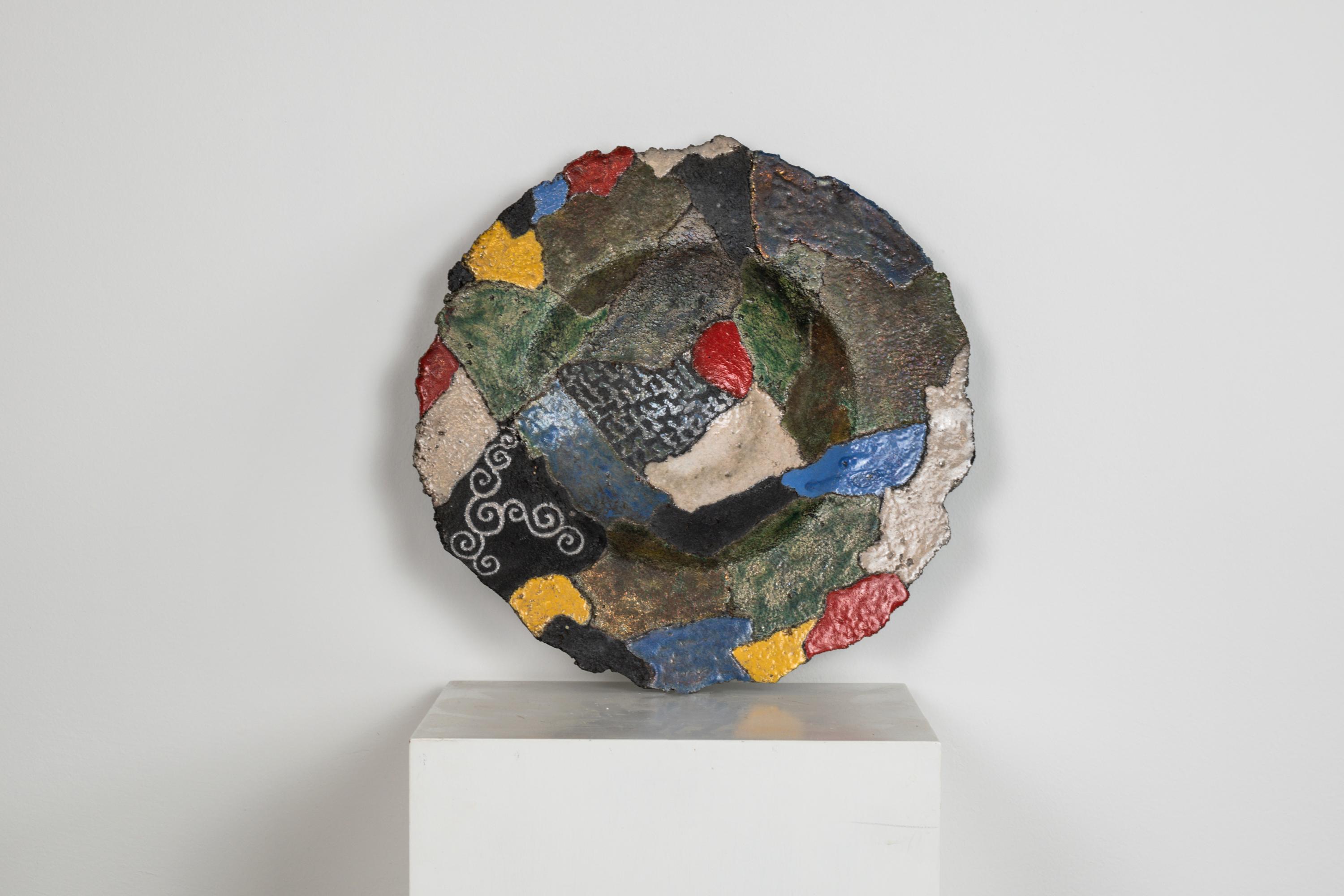 A beautiful and colorful decorative dish in polychrome ceramic manufactured by Giampaolo Mameli.
This ceramic dish from the 'Fragmenti' series mixed together different shades and texture obtained by the Raku technique, born in Japan in the 16th